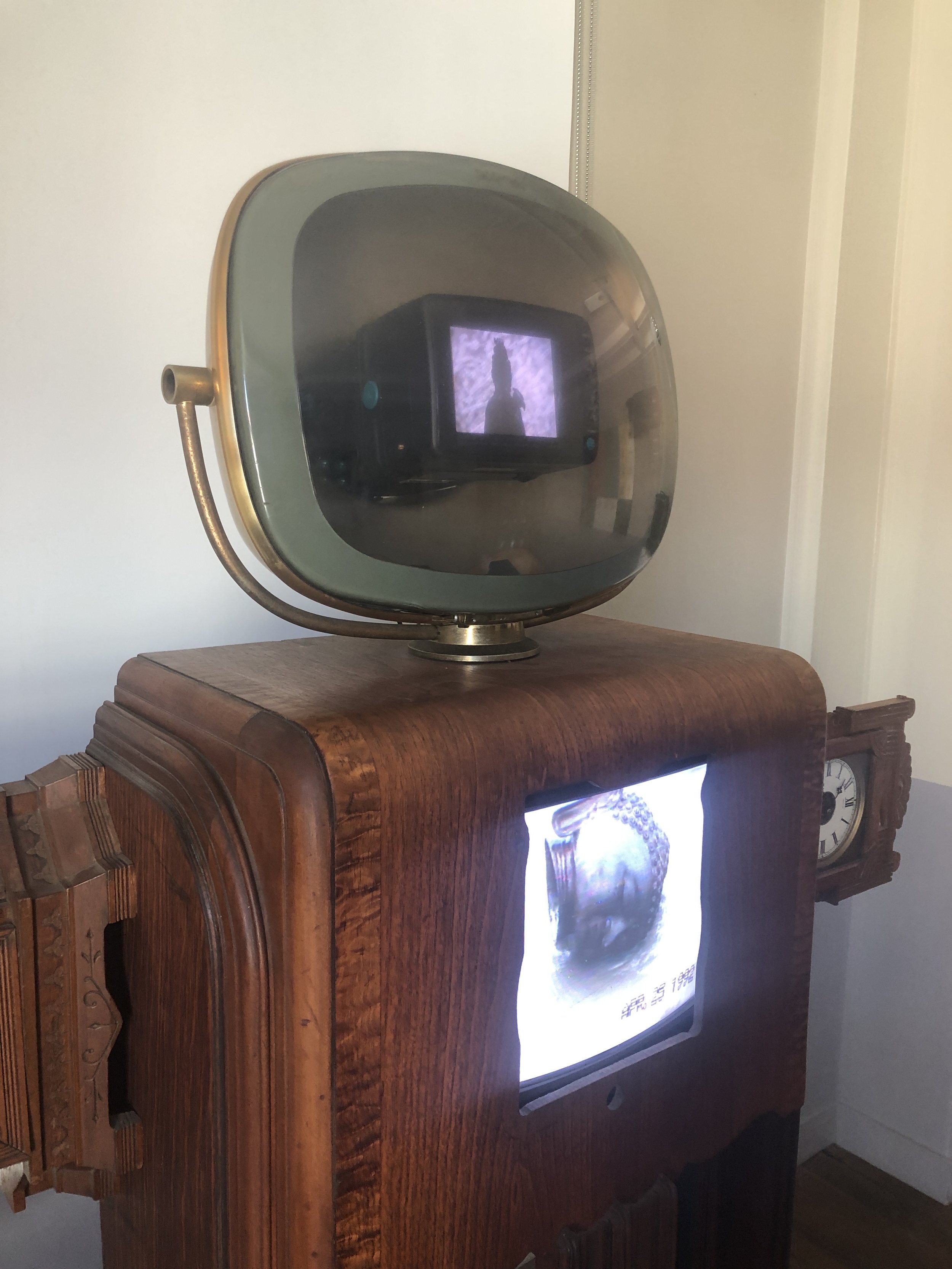  Nam June Paik,  Clock Arms Robot , 1995. Antique TV cabinet, antique clocks, two channel video and two video monitors. 72 x 61 x 21 inches.&nbsp;Installation at Felix Art Fair, 2020.  