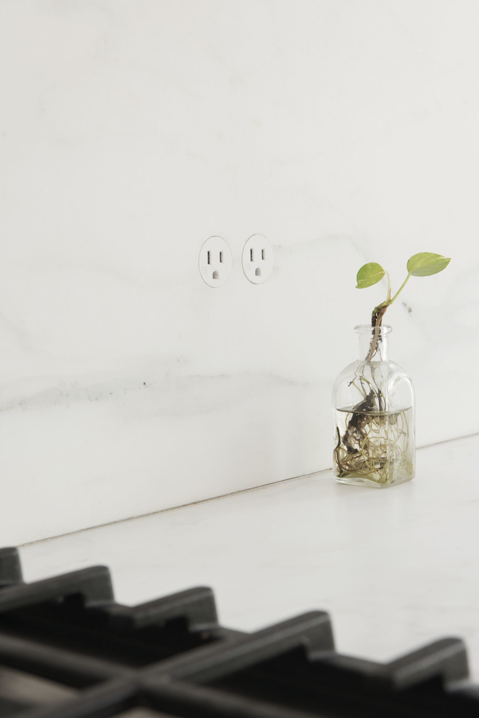  If you weren't looking for them, you wouldn't notice the ultra-subtle  Boffi  outlets embedded in the backsplash—and that's the point. 