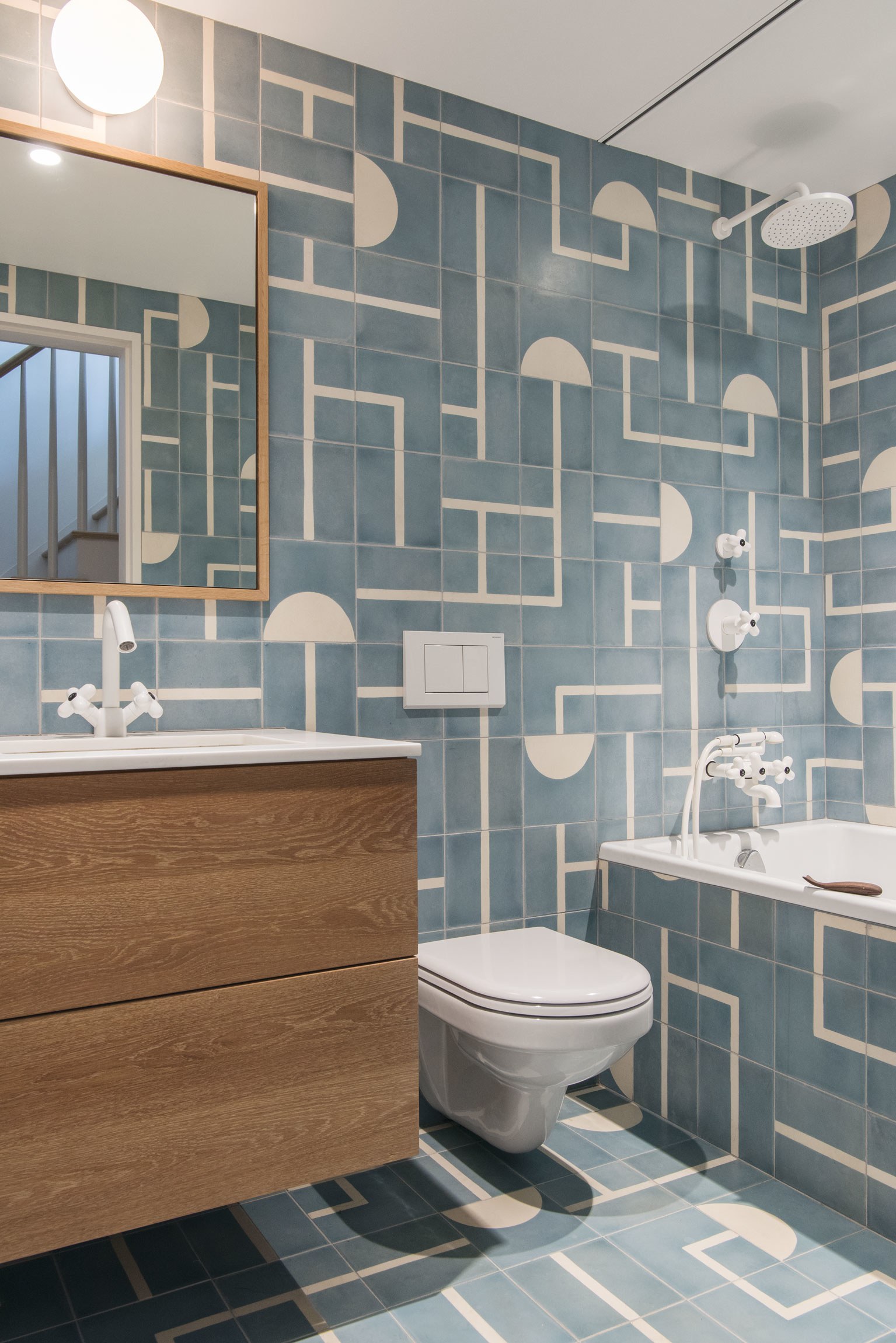  Roberts had fun with the kids' bathroom, covering it floor-to-ceiling in graphic  Popham Design  Brasilia tiles. "It has no windows, so the client wanted something that was fun and bright," she says. All of the fixtures play off of the pattern: the 