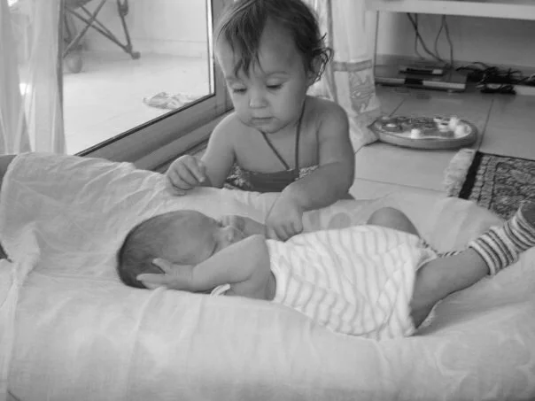 Frankie poking the new baby.jpg