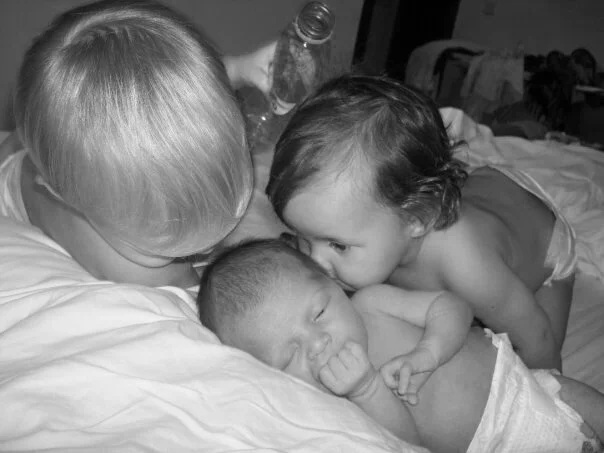 Twins kissing baby Tallulah.jpg