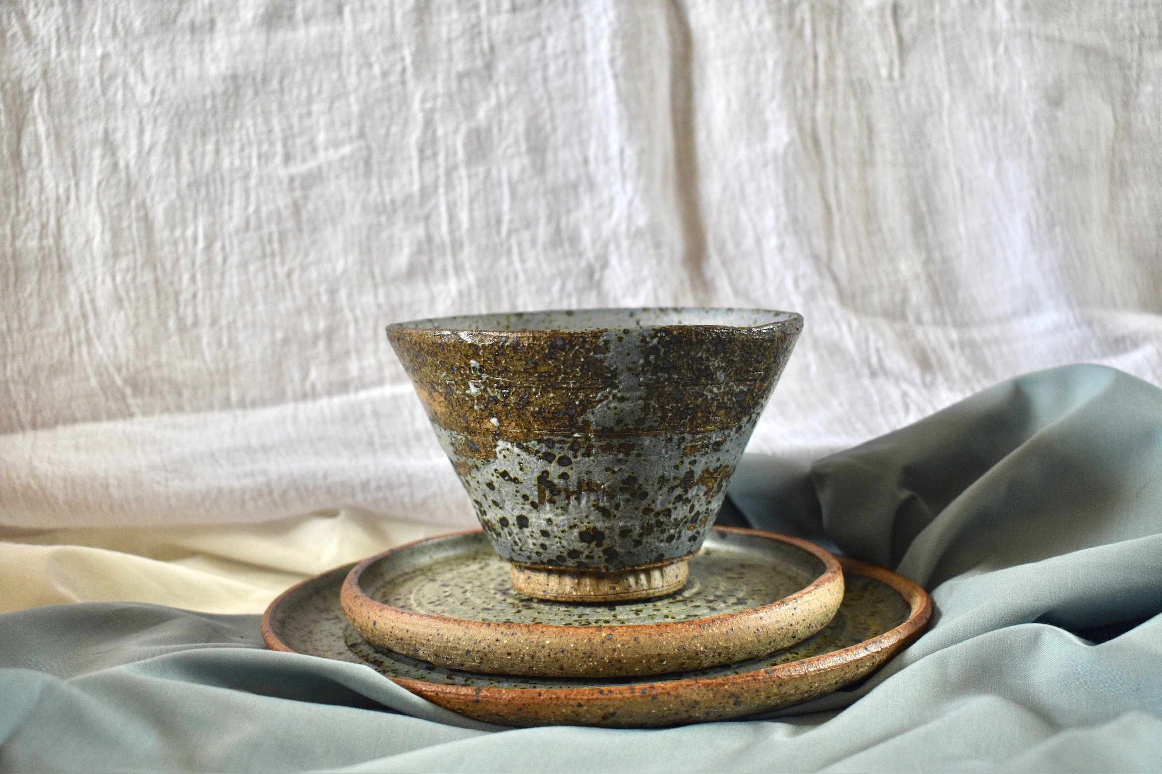 Medium footed bowl, side plate, and dinner plate, reduction fired stoneware