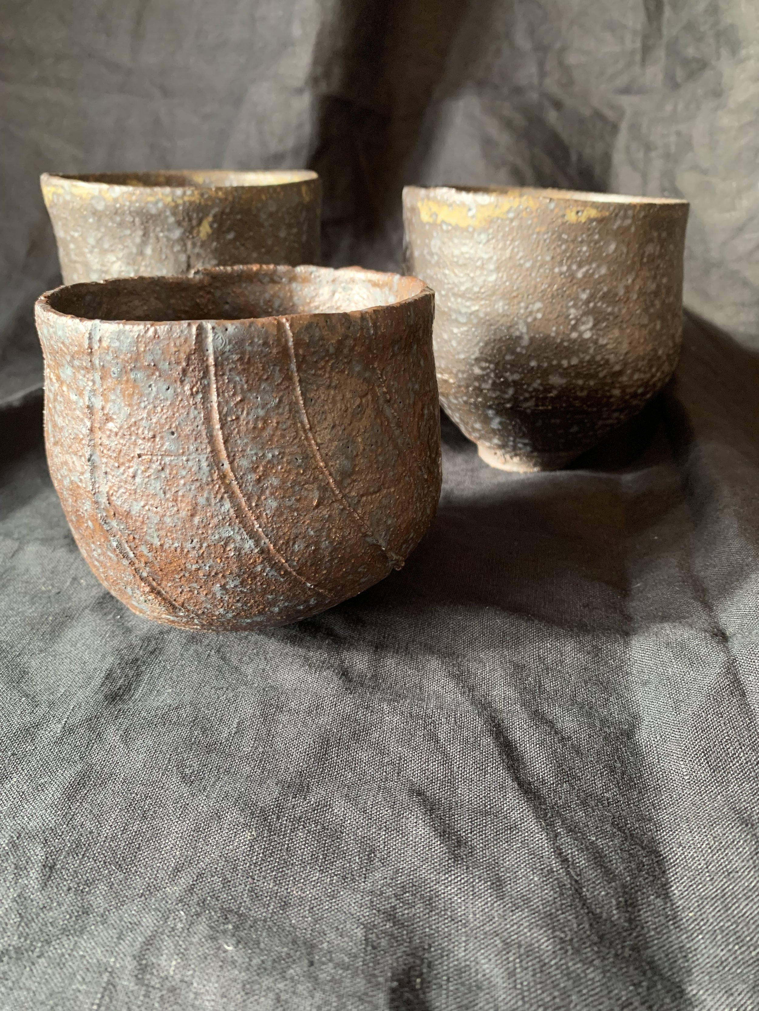 Three reduction fired stoneware cups