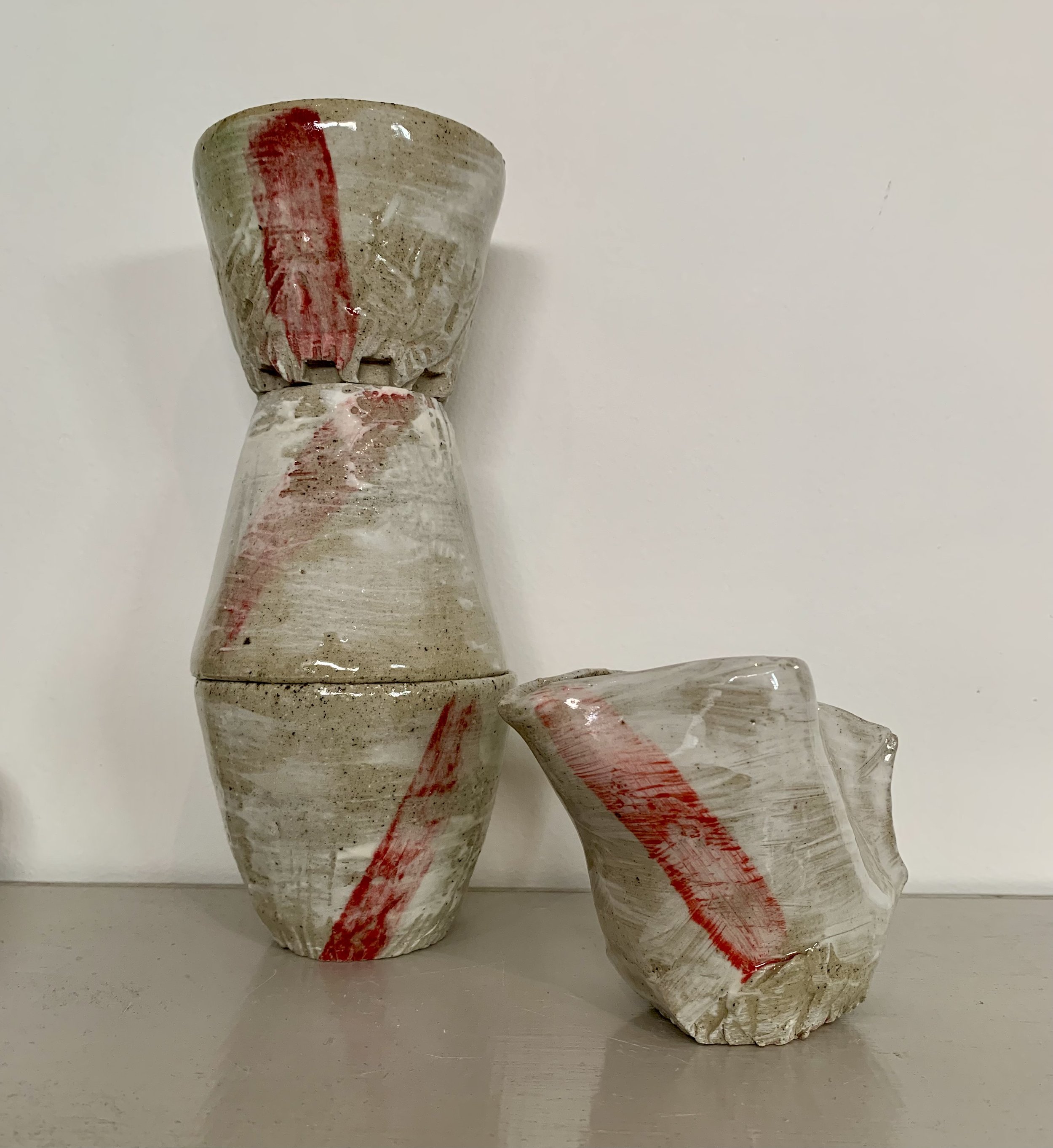 Three slip decorated and carved stoneware tumblers and pourer