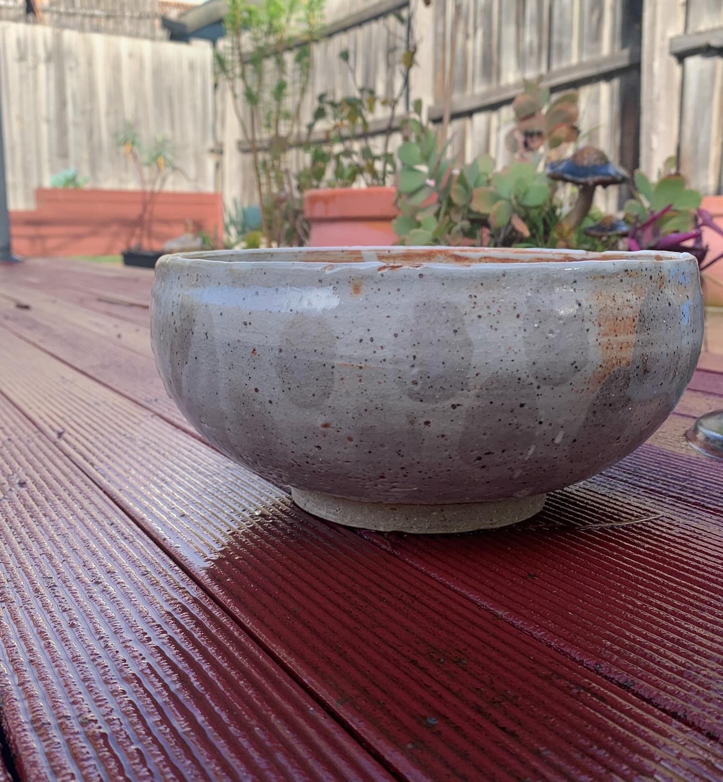 Large footed stoneware bowl with shino and ash glaze decoration