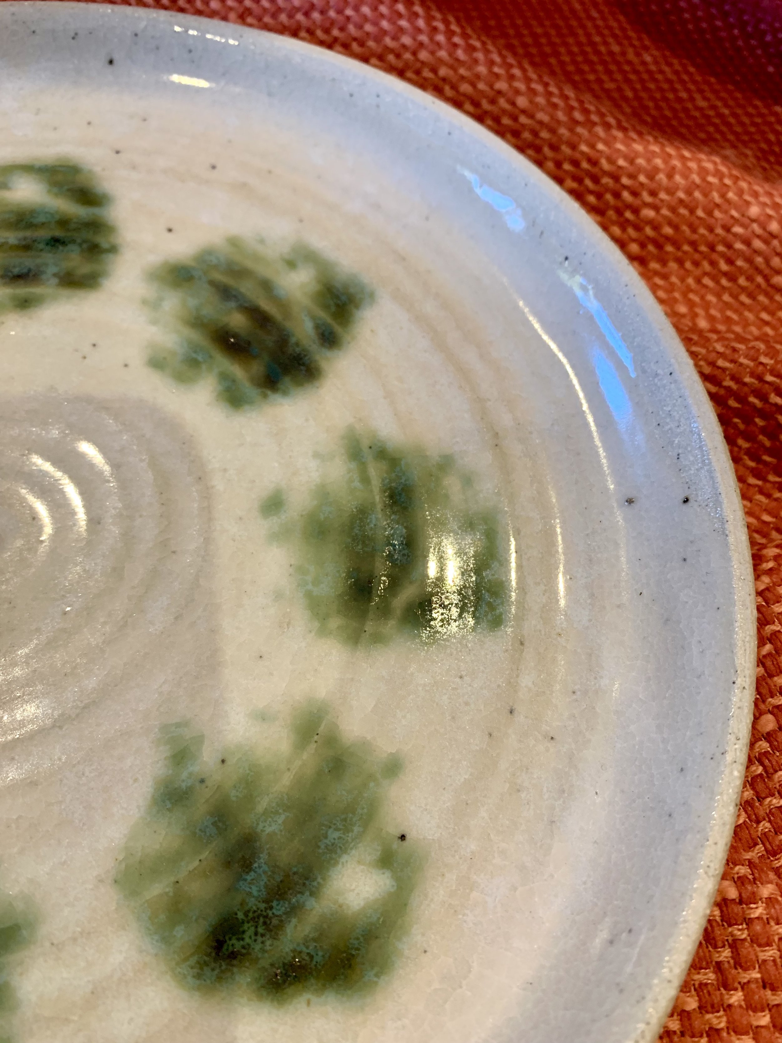 Detail of serving plate with copper oxide decoration on shino and ash glazed stoneware