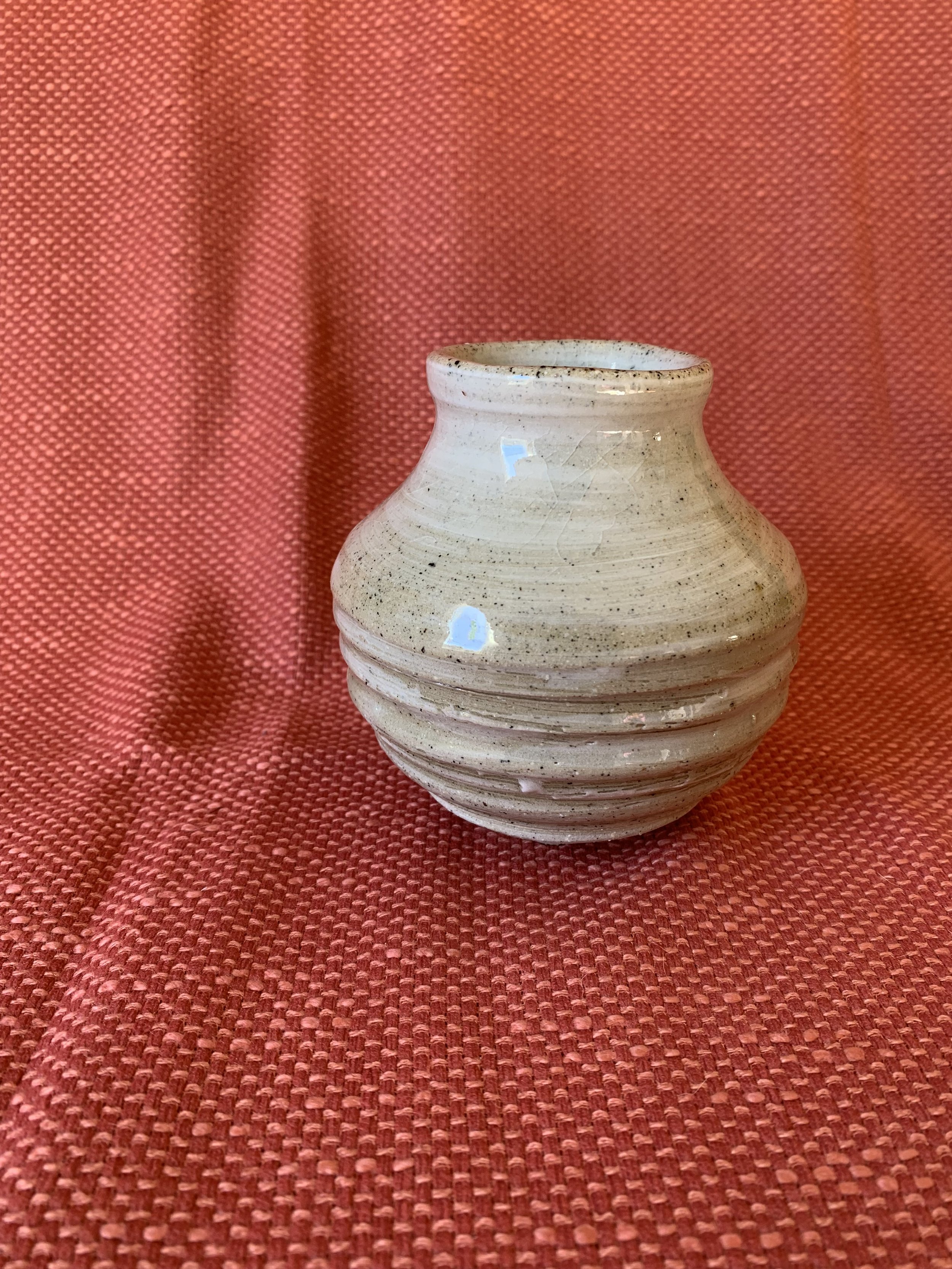 Small slip decorated footed stoneware vase