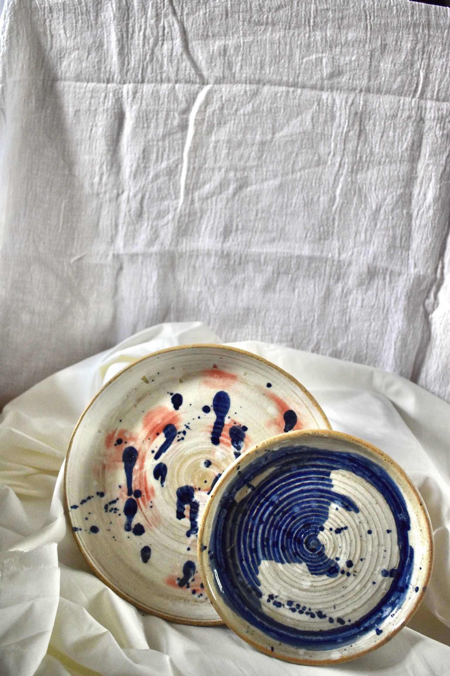 Large slip decorated serving plate and side plate, glazed stoneware