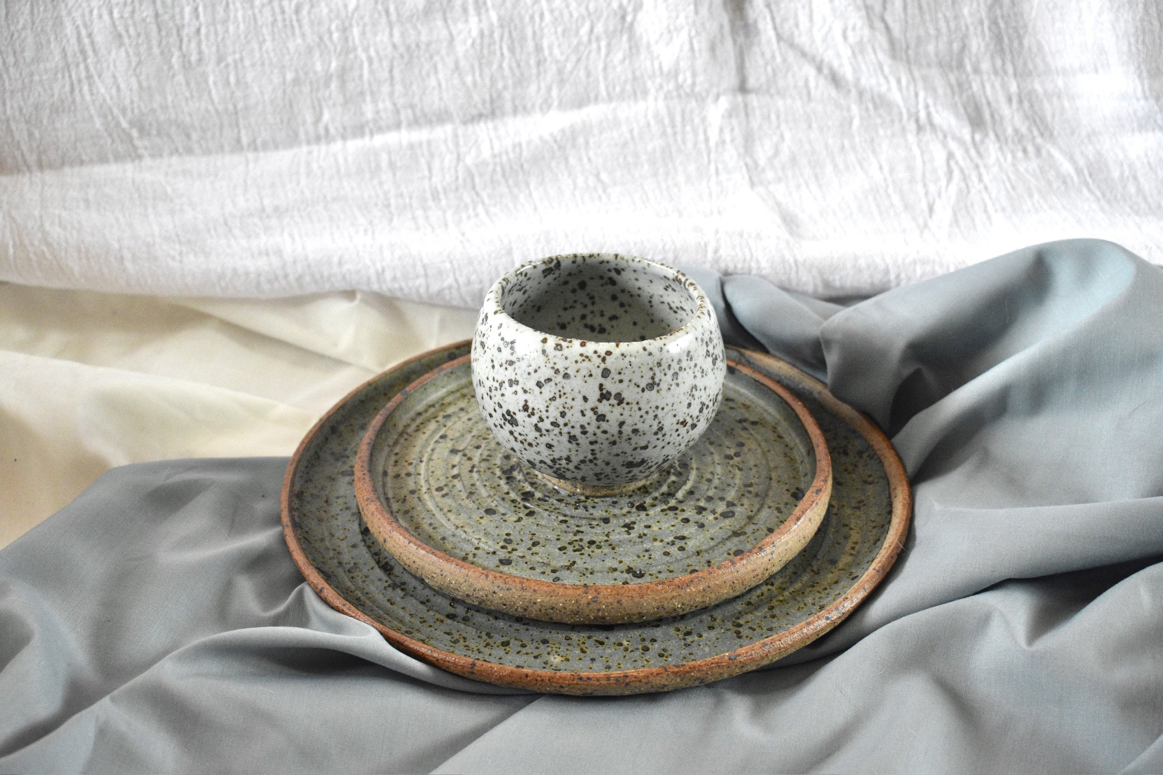 Small footed bowl, side plate, and dinner plate, reduction fired stoneware