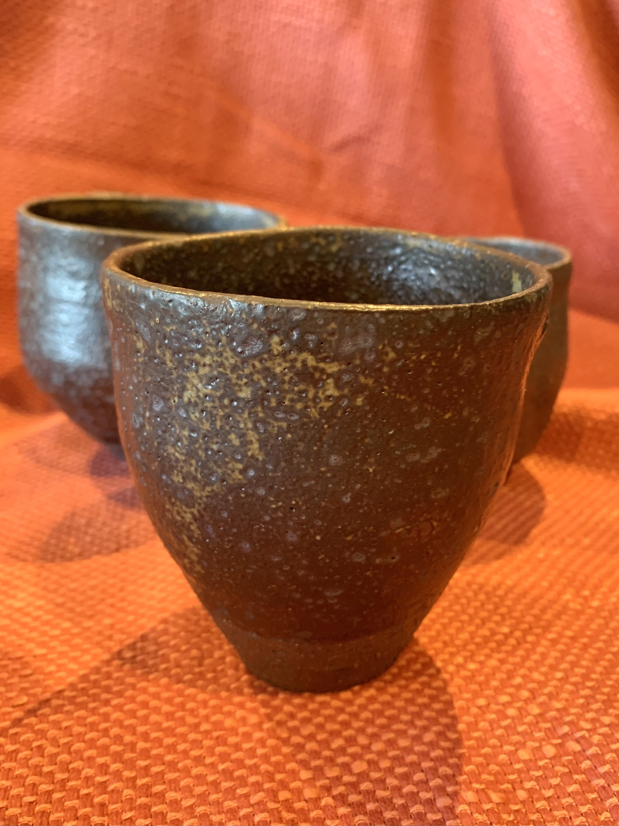 Tapered cup, dark reduction fired stoneware