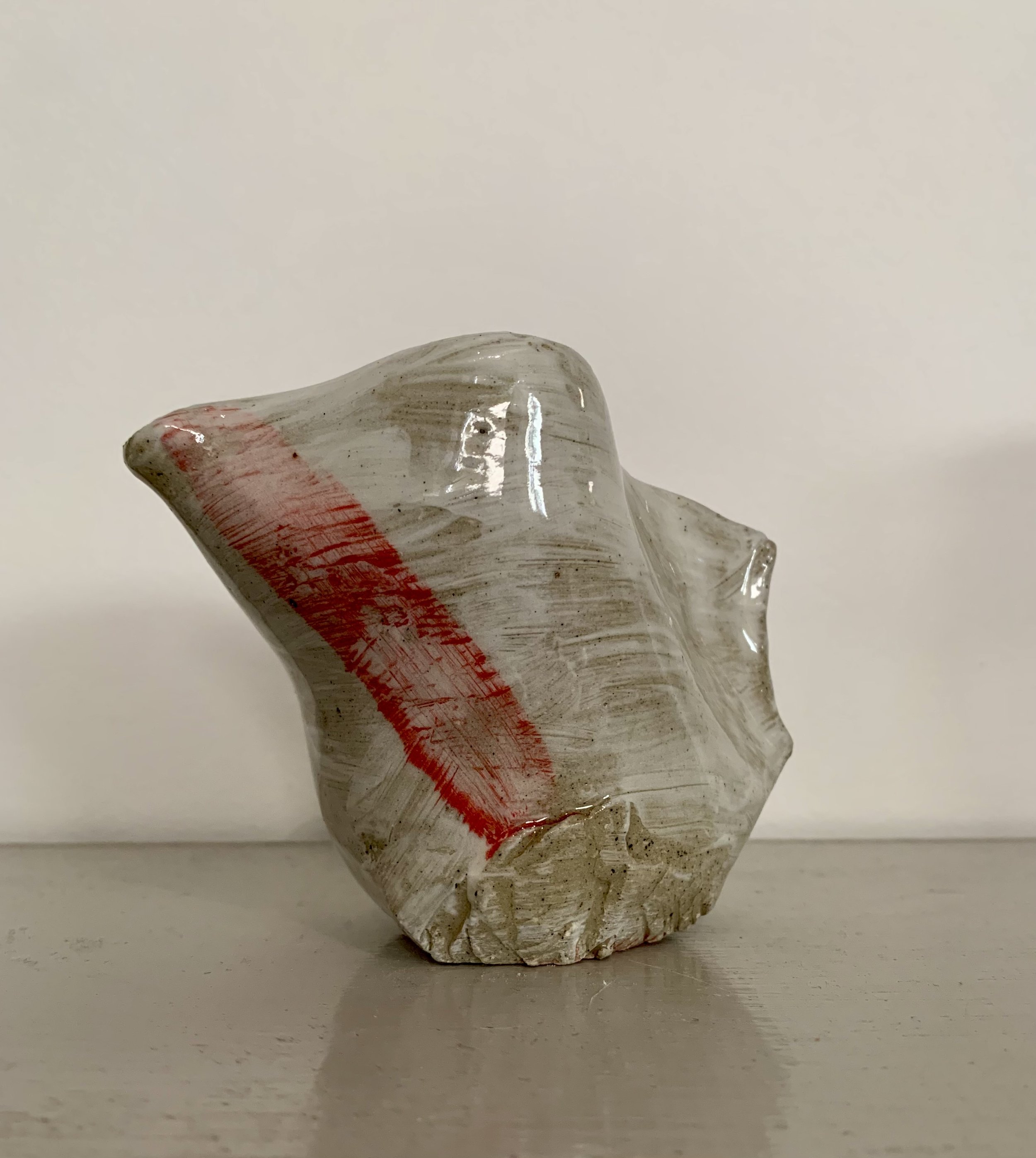 Thrown and altered, slip decorated and carved stoneware pourer