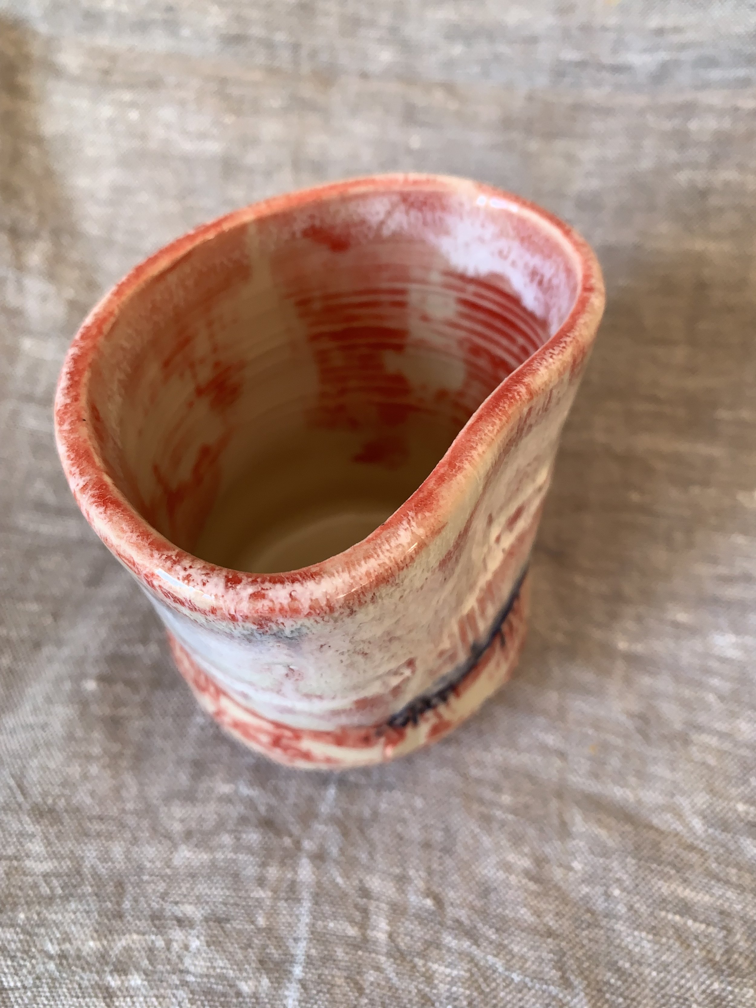 Small carved stoneware tumbler decorated with red slip and cobalt oxide