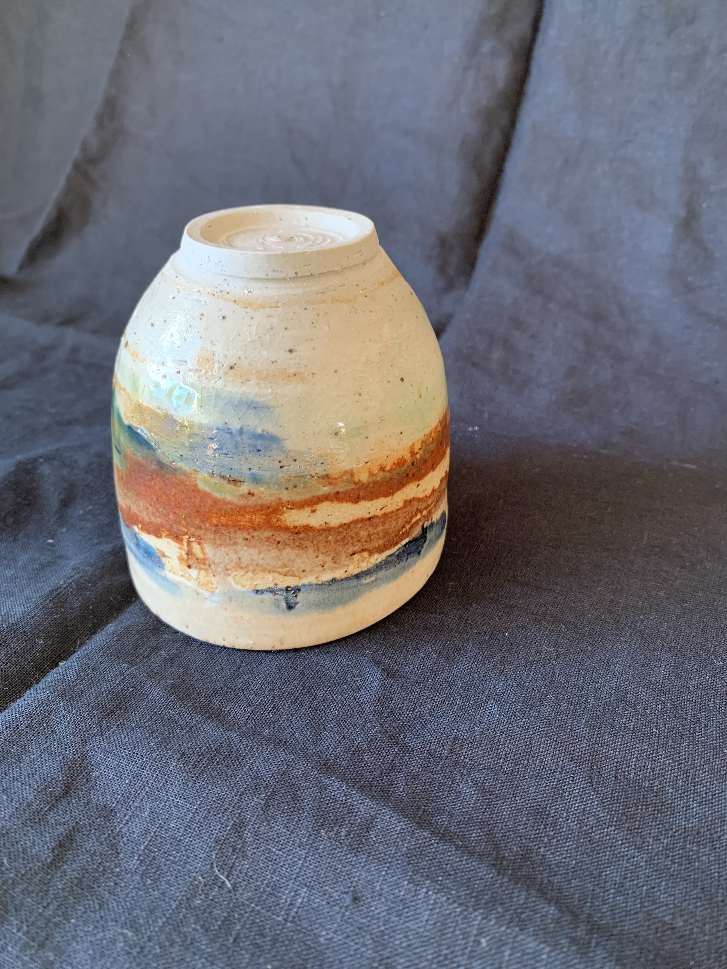 Stoneware cup decorated with oxides made from reclaimed metals and glazes incorporating reclaimed materials