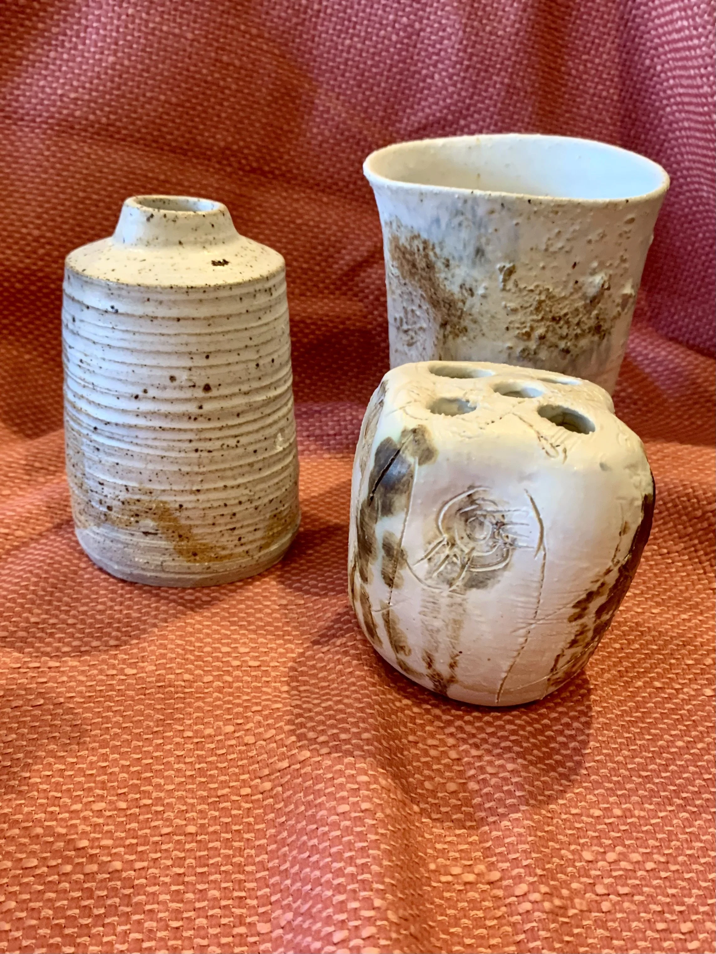 Thrown and altered stoneware vase with texture and oxide colouring, thrown and textured narrow-necked stoneware vase, and thrown and altered stem vase with texture and oxide colouring