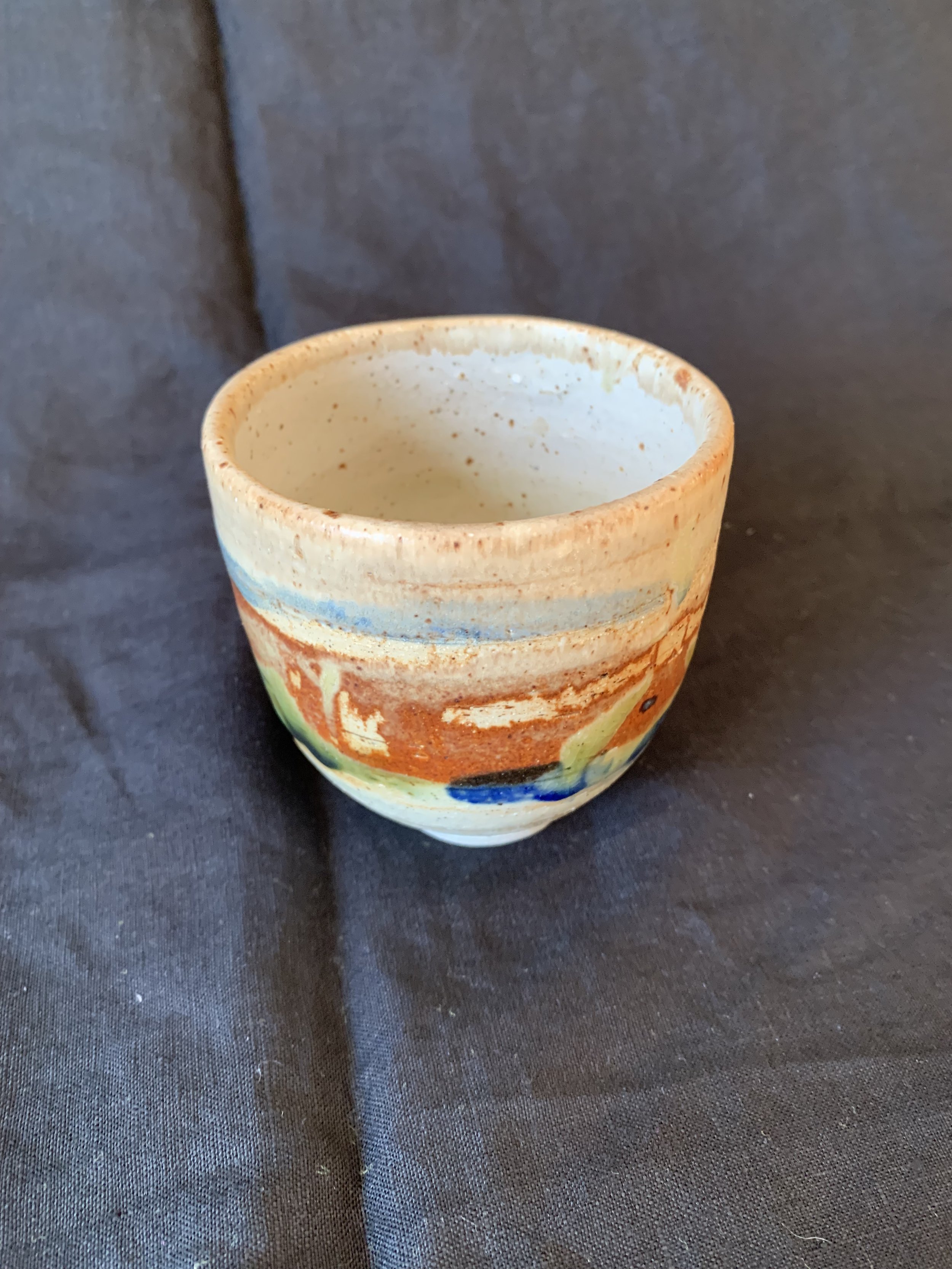 Stoneware cup decorated with oxides made from reclaimed metals and glazes incorporating reclaimed materials