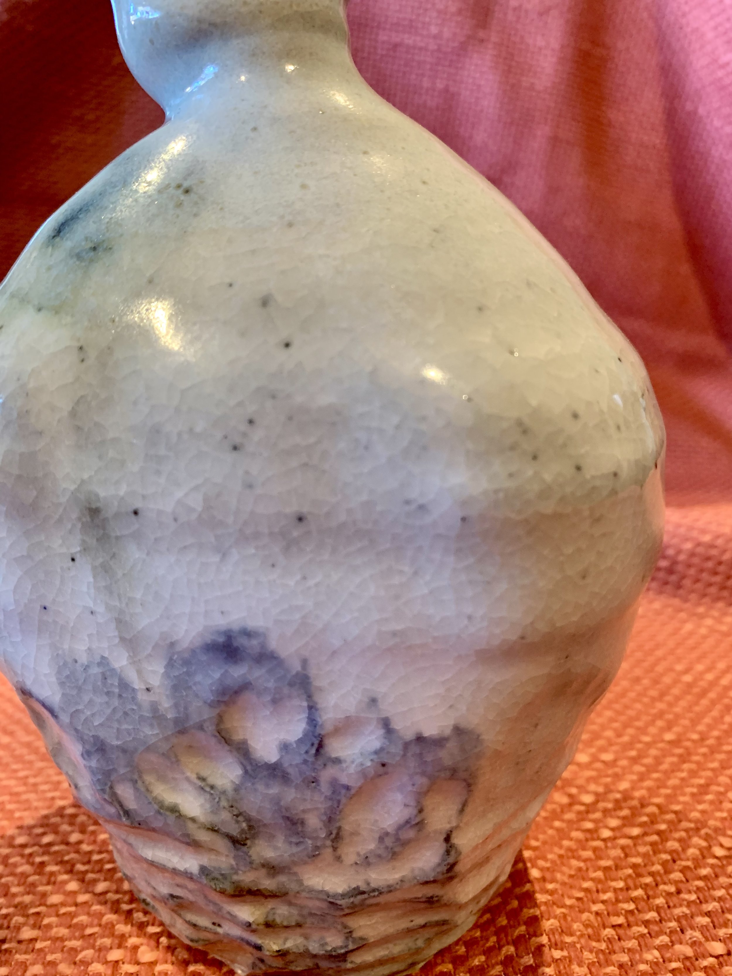 Detail of soneware bottle, slip and oxide decoration over shino glaze with ash glazed neck