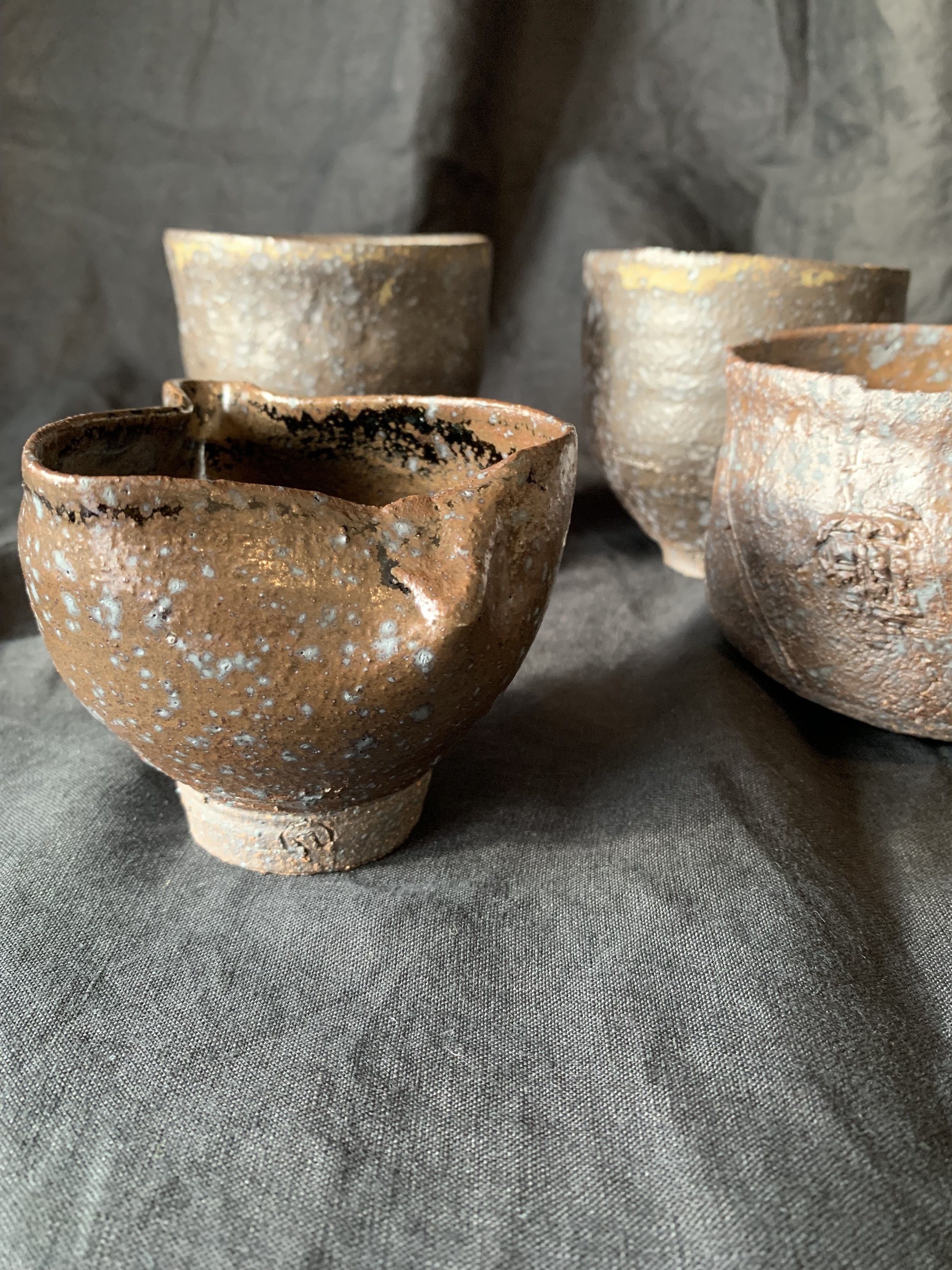 Three reduction fired stoneware cups with pourer
