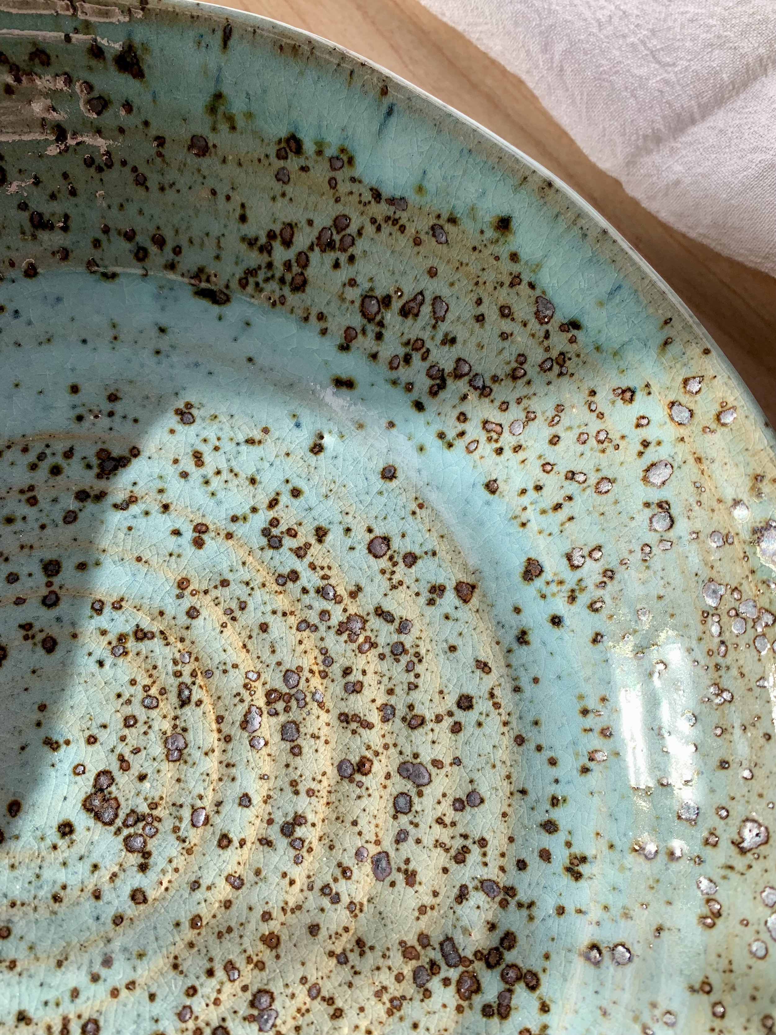 Detail of large serving dish, stoneware with blue Chun glaze, reduction fired.