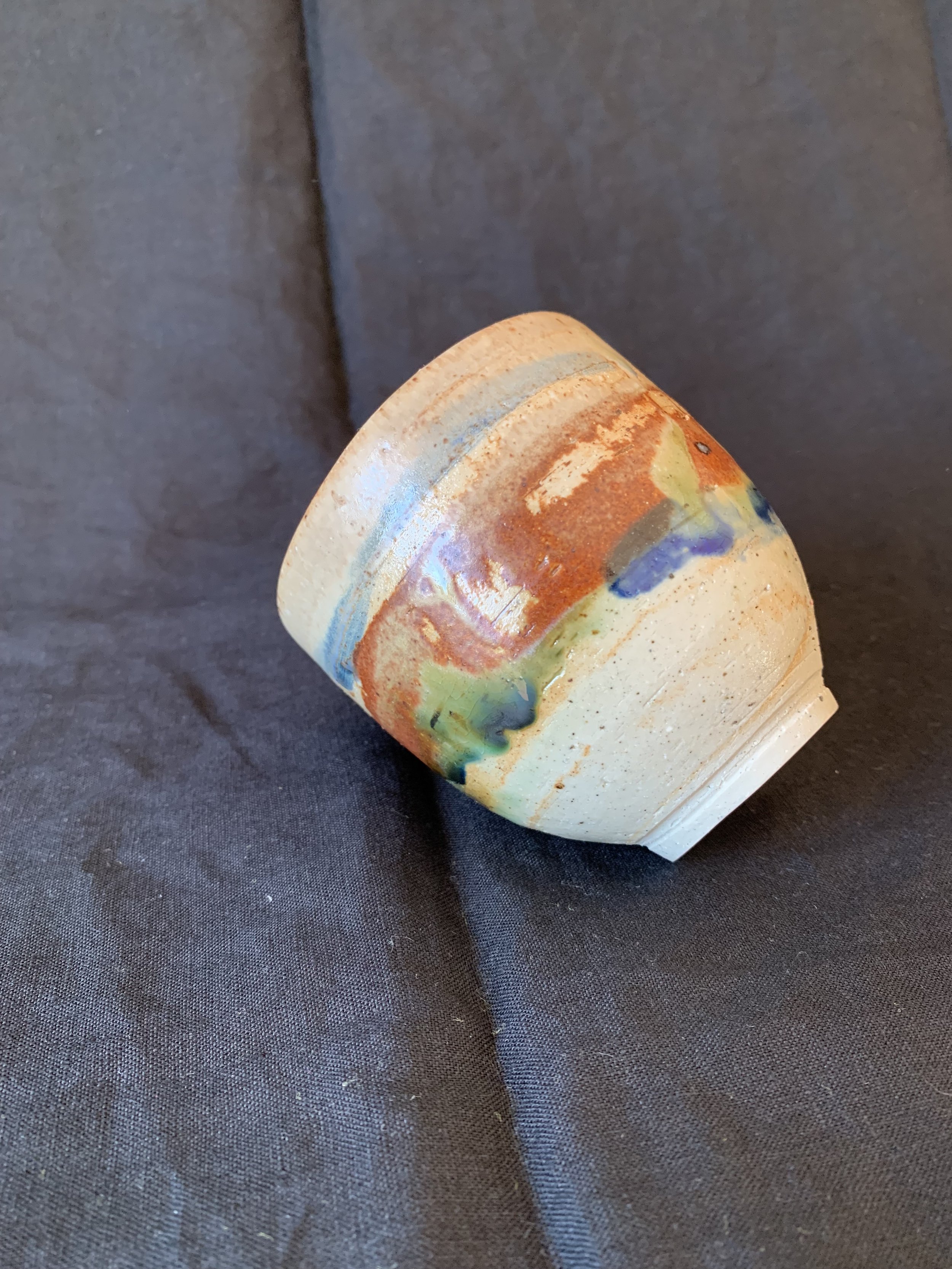 Stoneware cup decorated with oxides made from reclaimed metals and glazes incorporating reclaimed materials