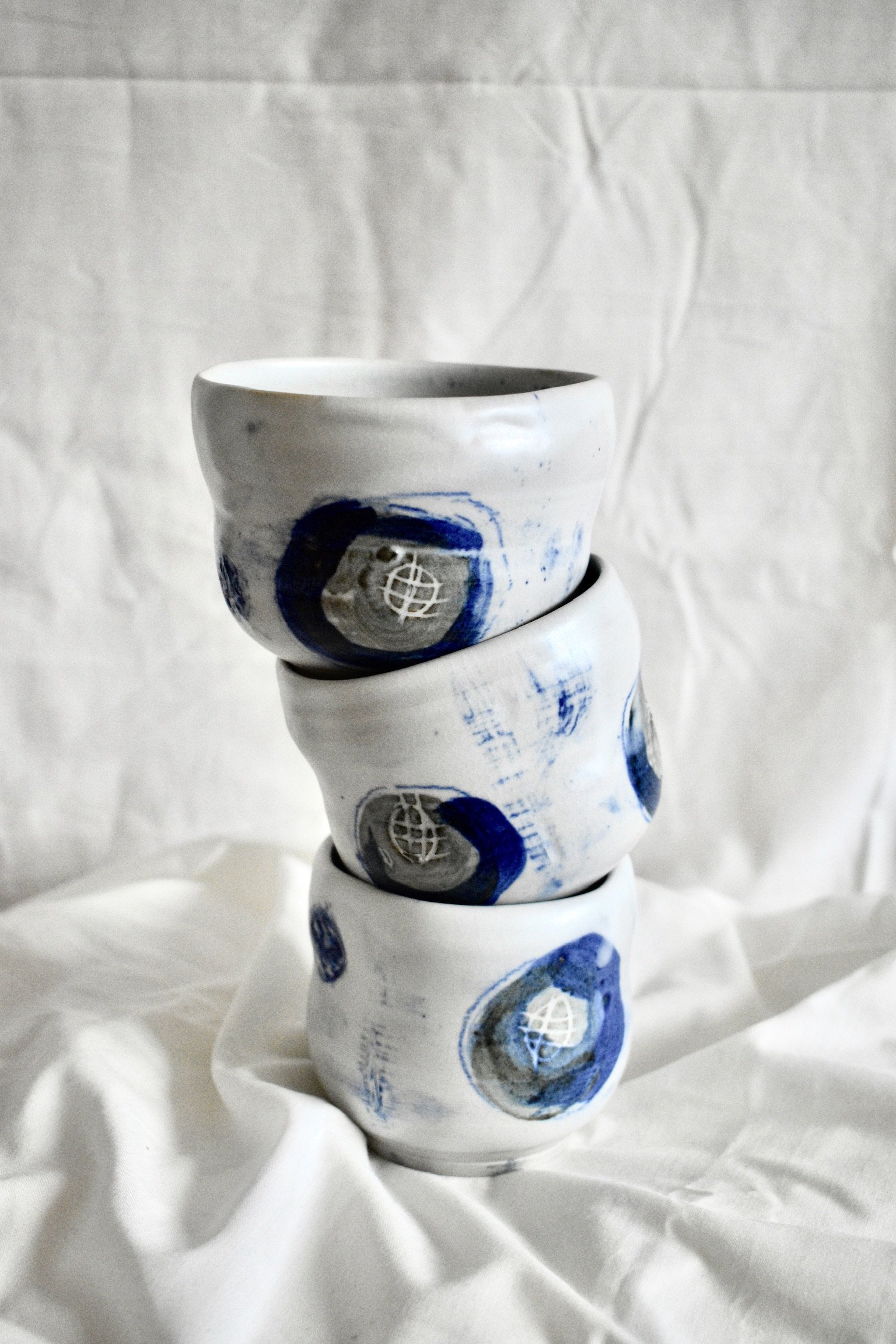 Cups, stoneware with slips, oxides, and glaze.
