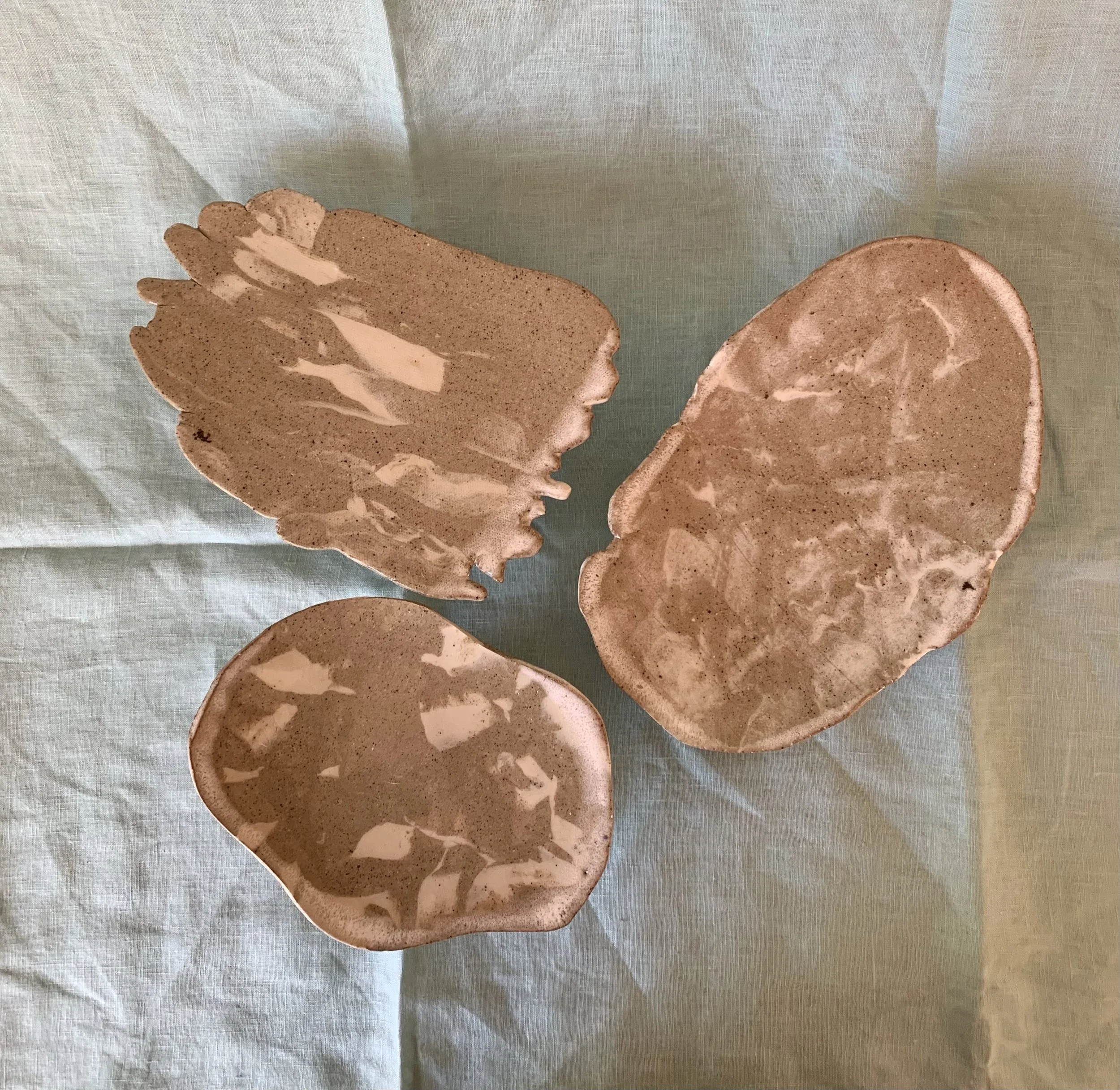 Three medium stilted Nerikomi serving dishes, clear glazed stoneware with slip