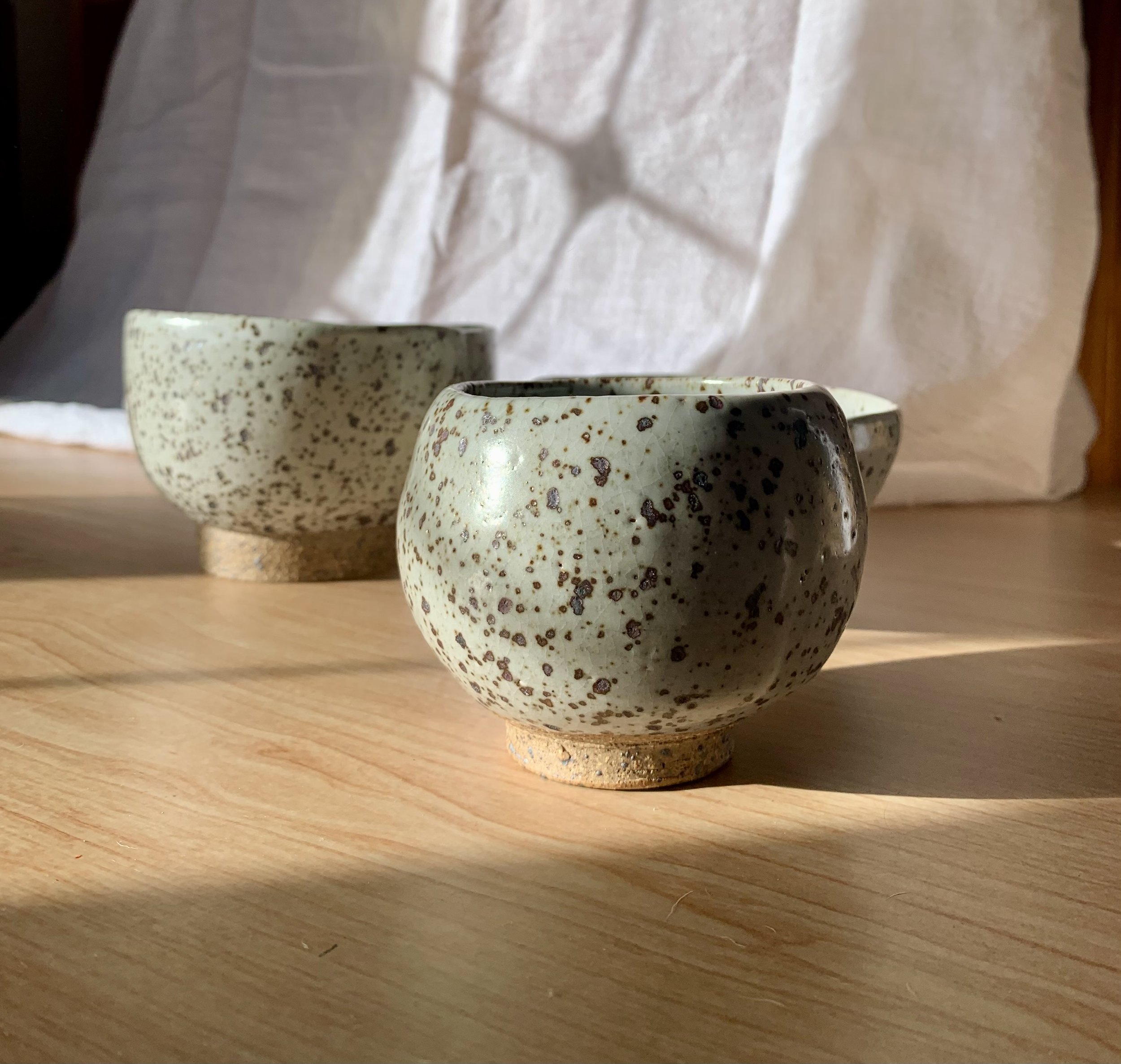 Set of three small footed bowls, reduction fired stoneware