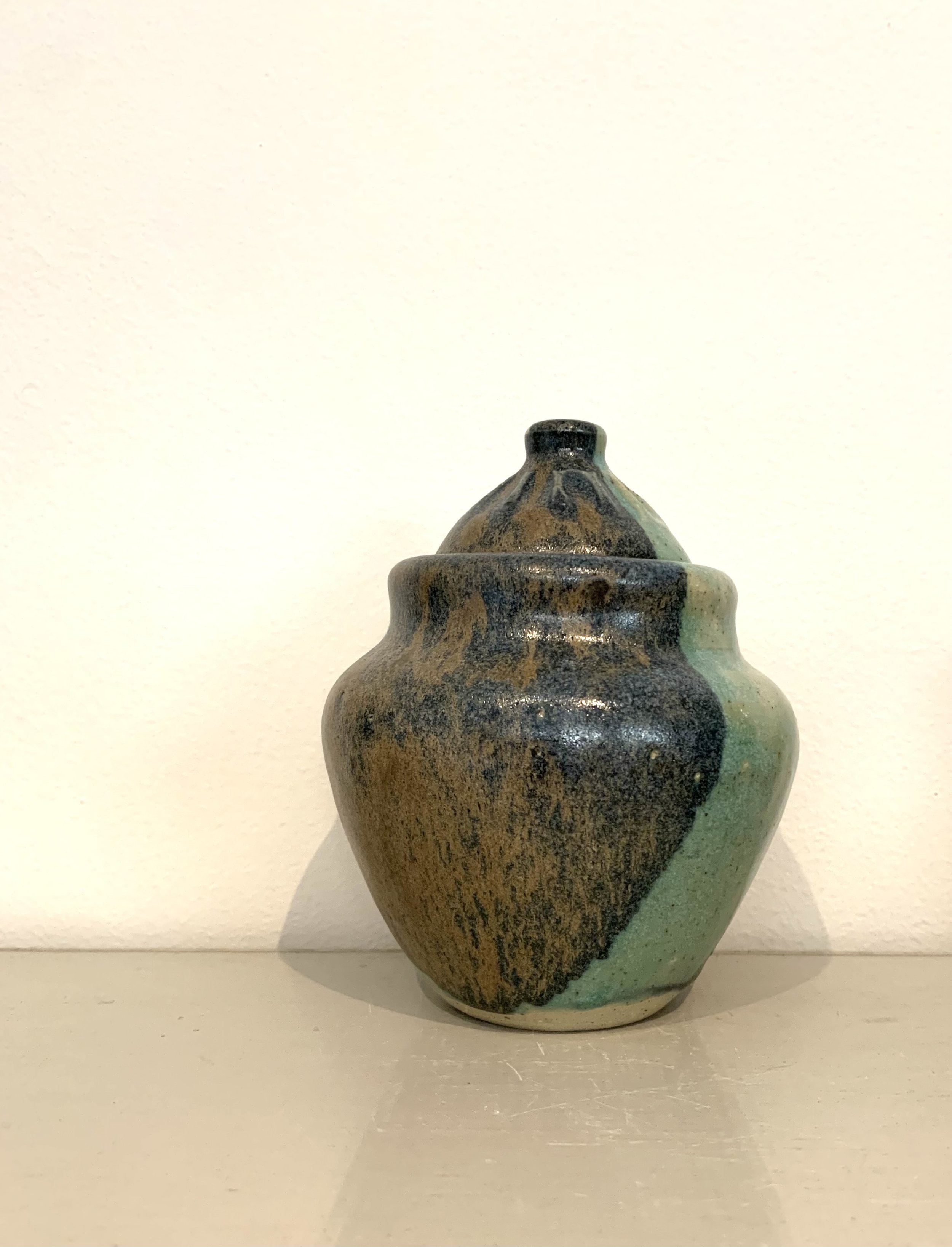 Thrown lidded jar, bronze and green glazed stoneware