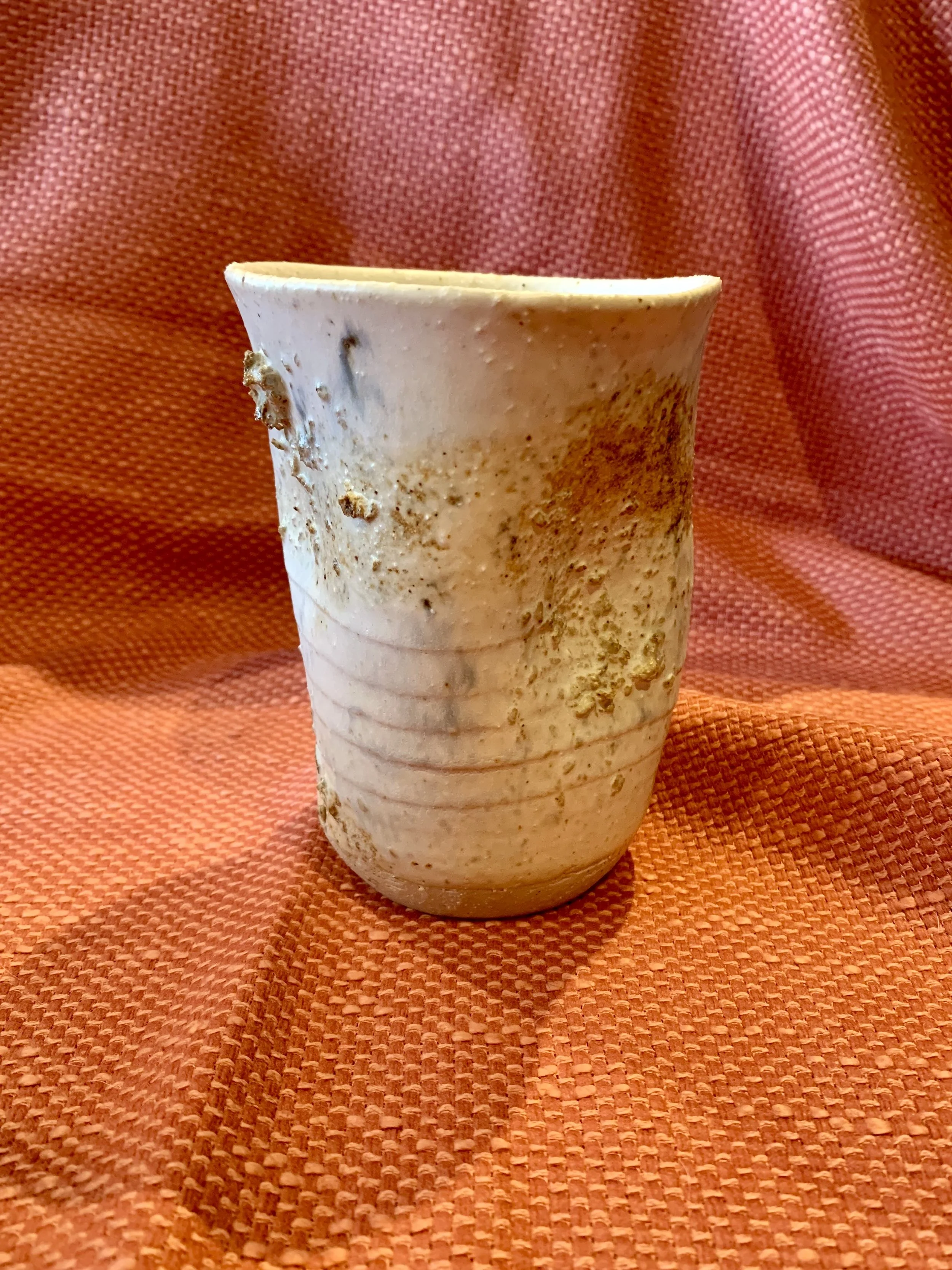 Thrown and altered stoneware vase with texture and oxide colouring