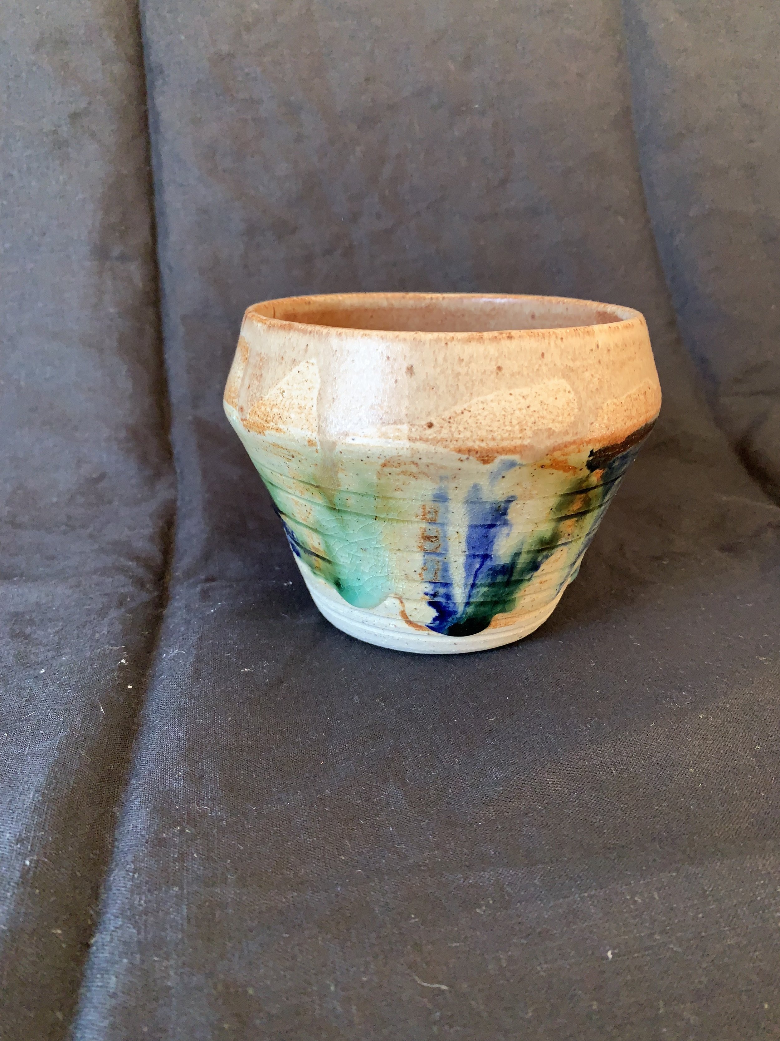 Stoneware vessel decorated with oxides and glazes incorporating reclaimed materials