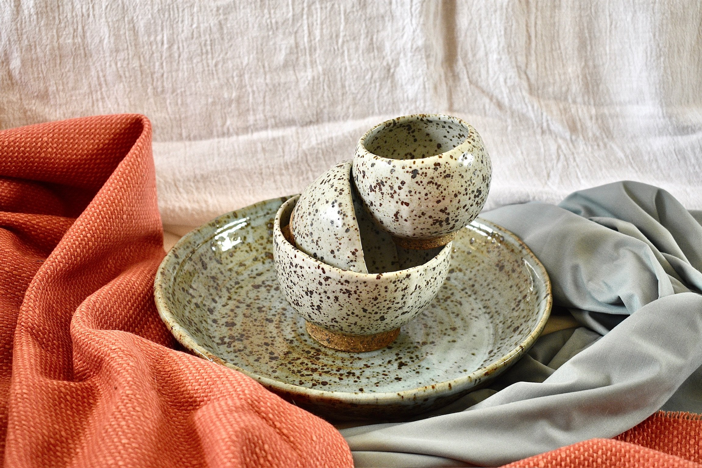 Set of three small footed bowls and large serving dish, reduction fired stoneware
