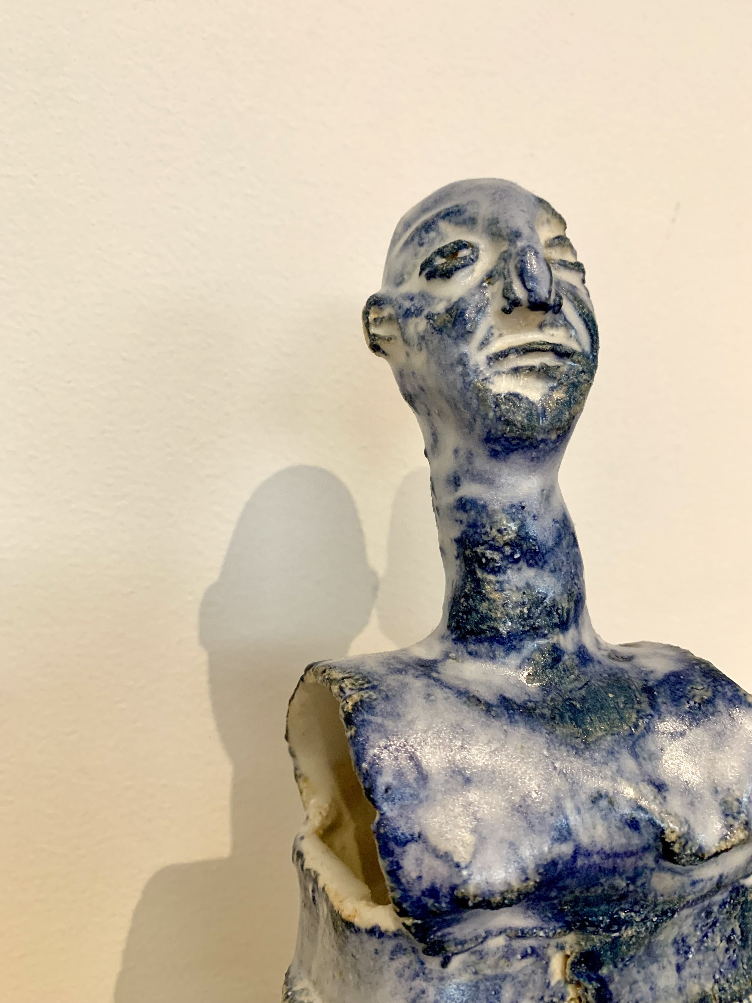 Detail of Blue figure, 2025, Raku clay, coloured slip, glaze