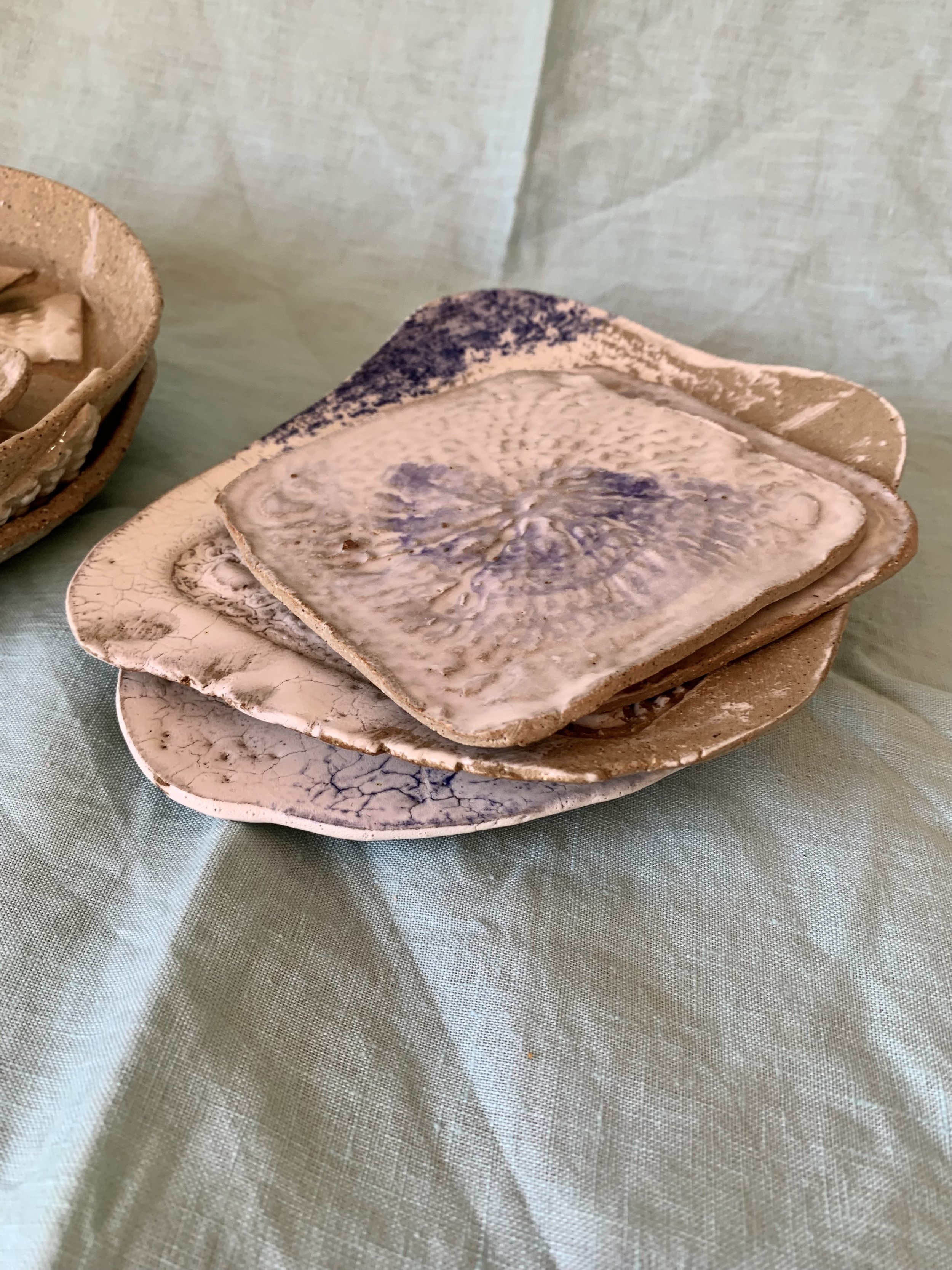 Slip-decorated stoneware coasters and serving dishes