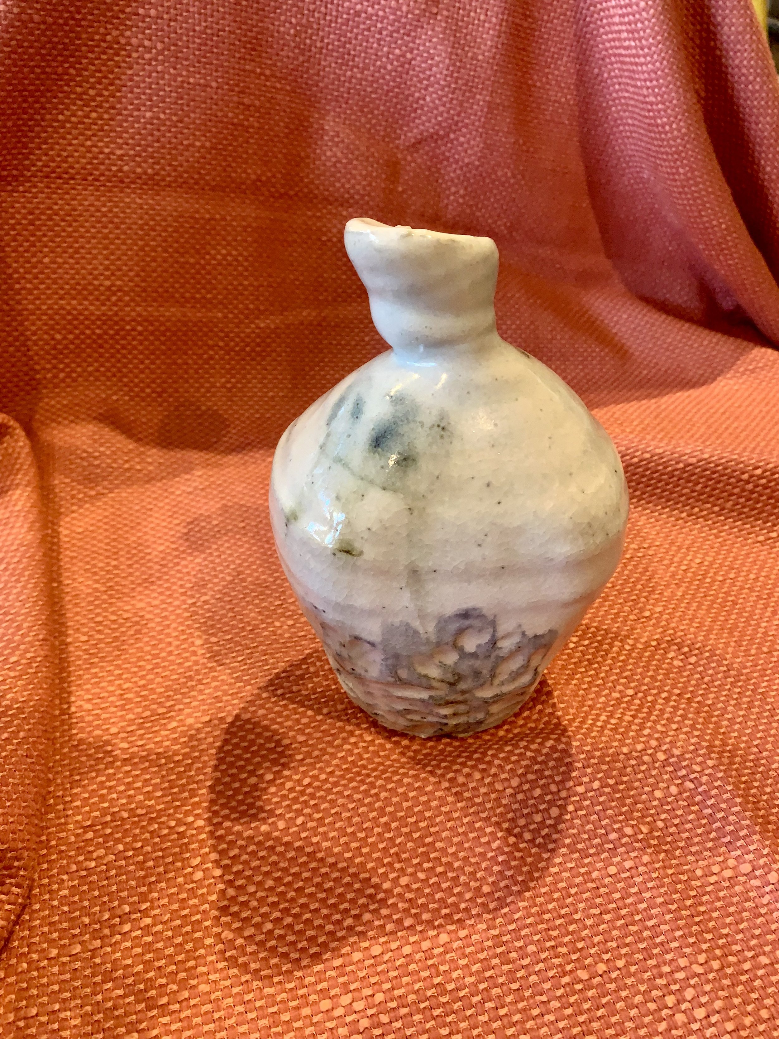Detail of stoneware bottle, slip and oxide decoration over shino glaze with ash glazed neck