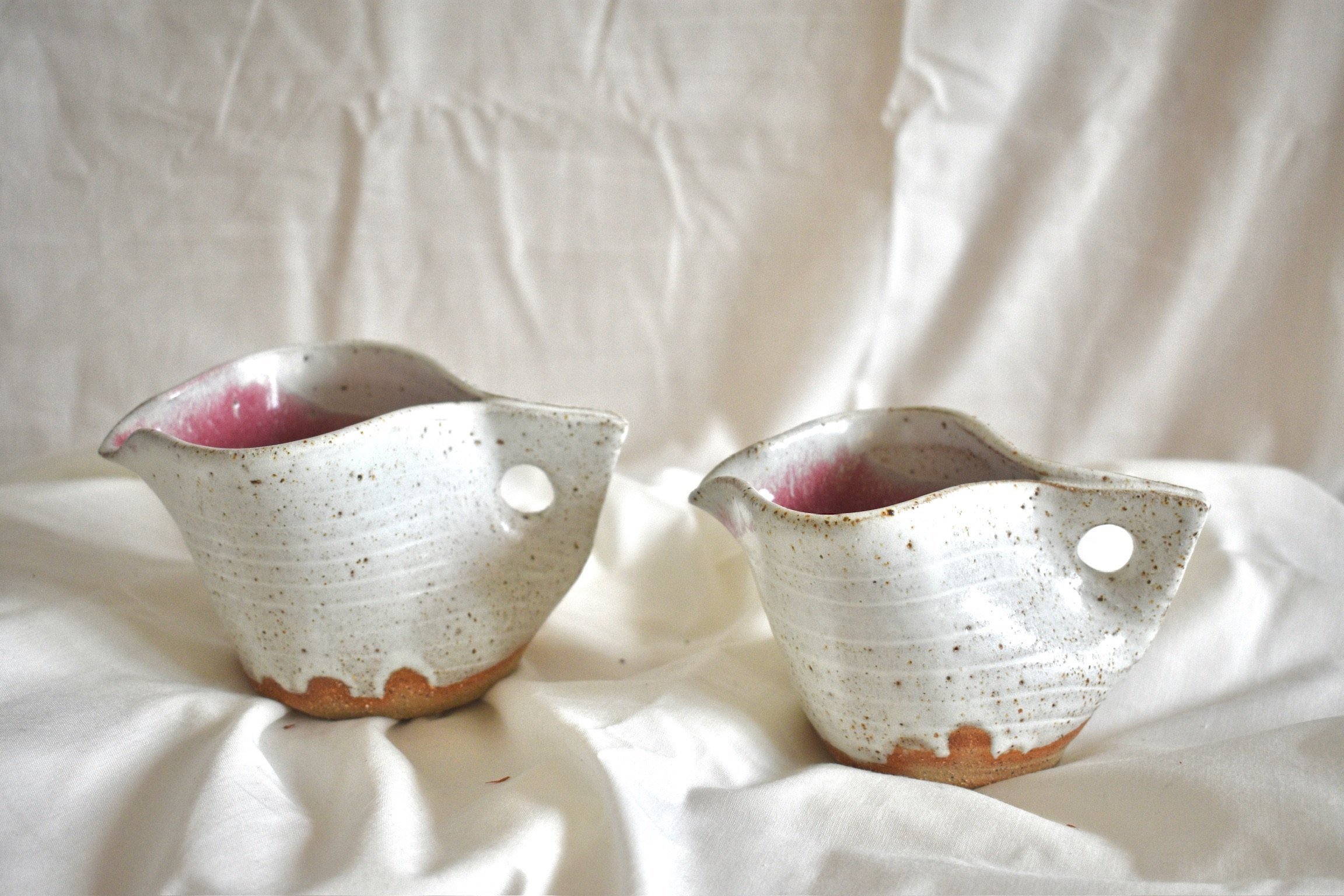 Pink and white birdie jugs, glazed stoneware