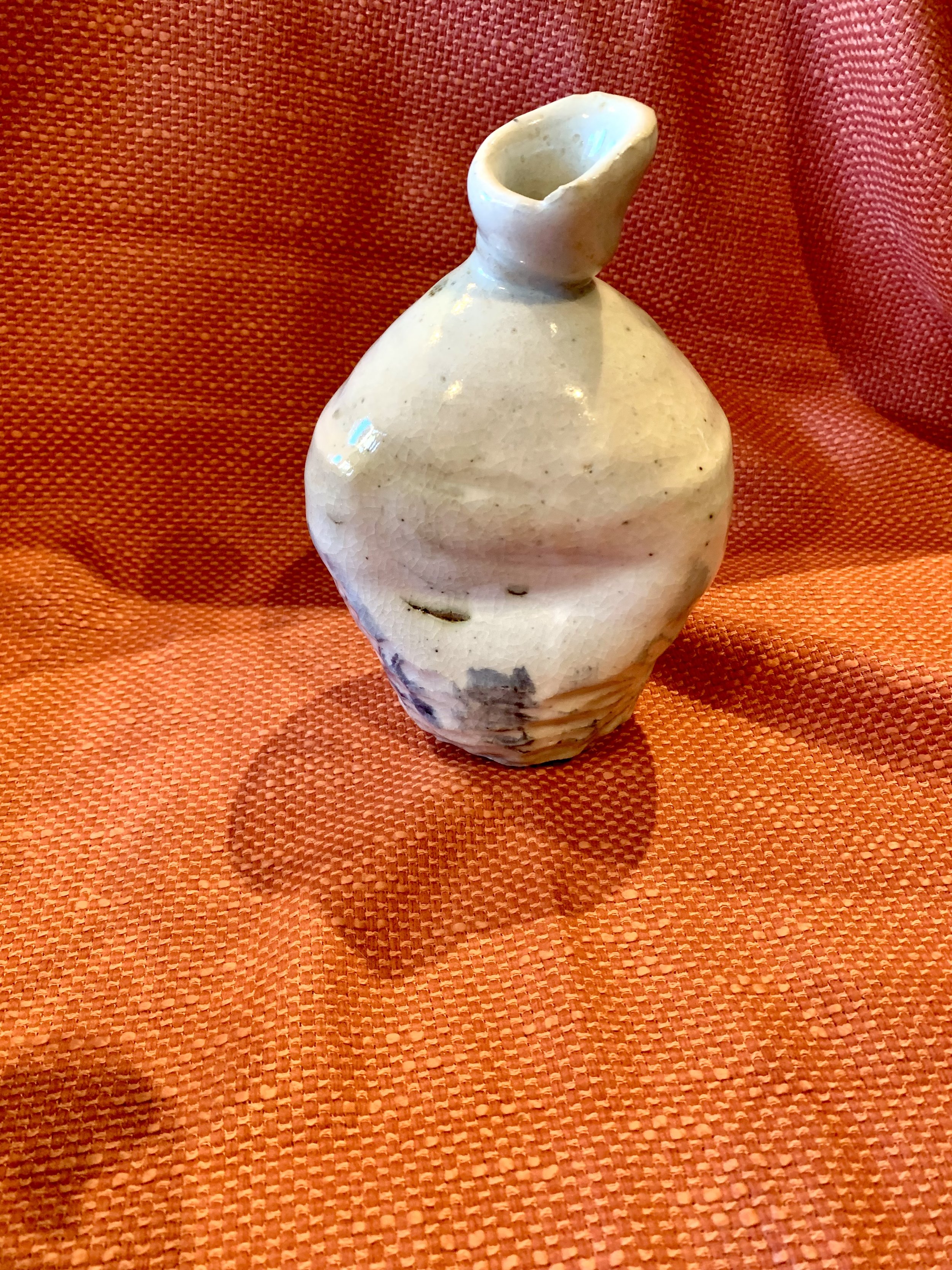 Stoneware bottle, slip and oxide decoration over shino glaze with ash glazed neck