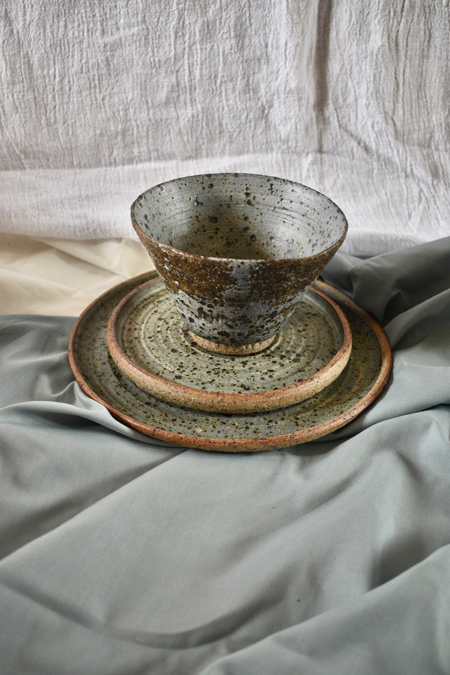Medium footed bowl, side plate, and dinner plate, reduction fired stoneware