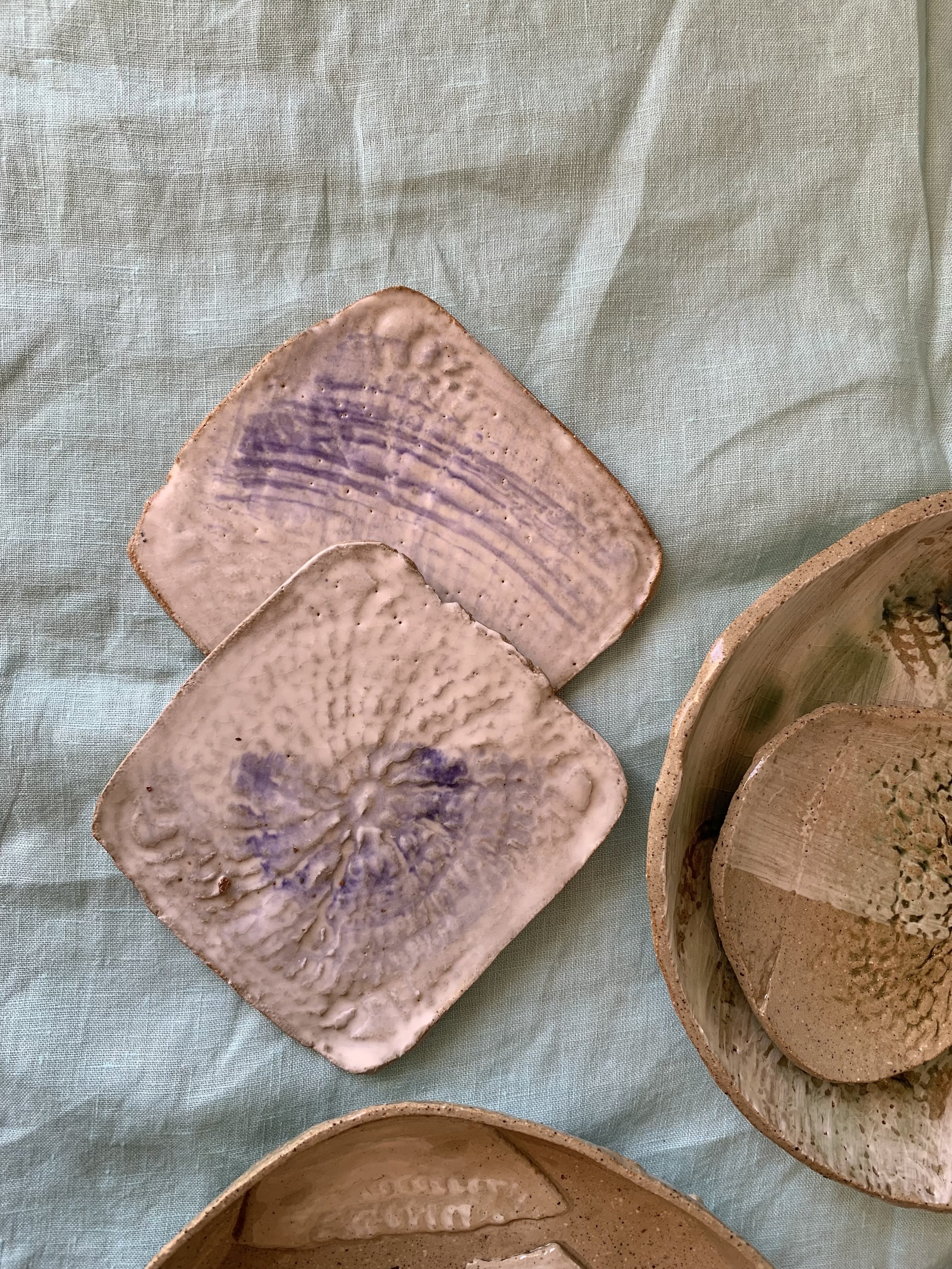 Two slip-decorated stoneware coasters