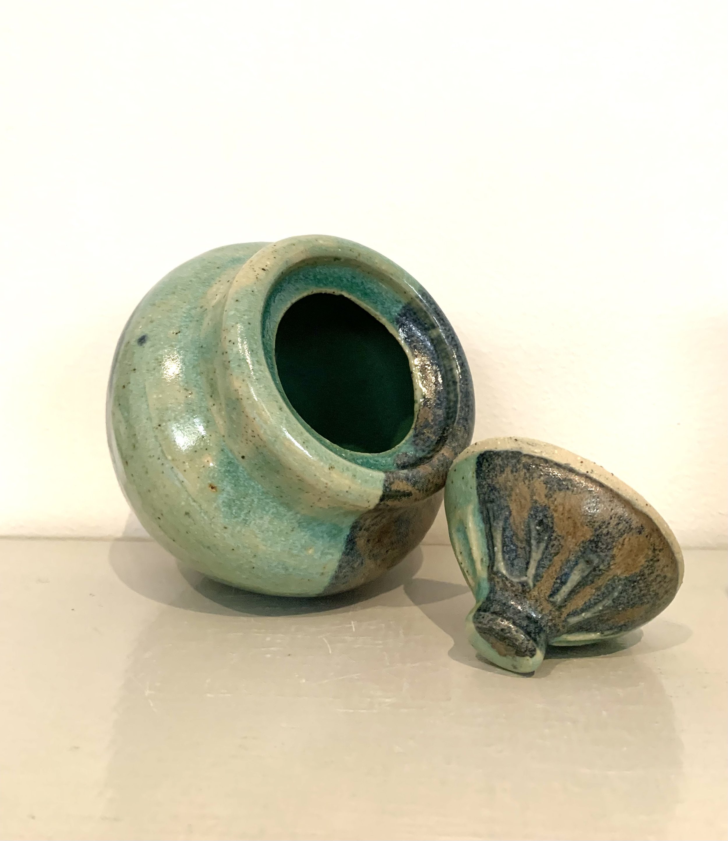 Thrown lidded jar, bronze and green glazed stoneware