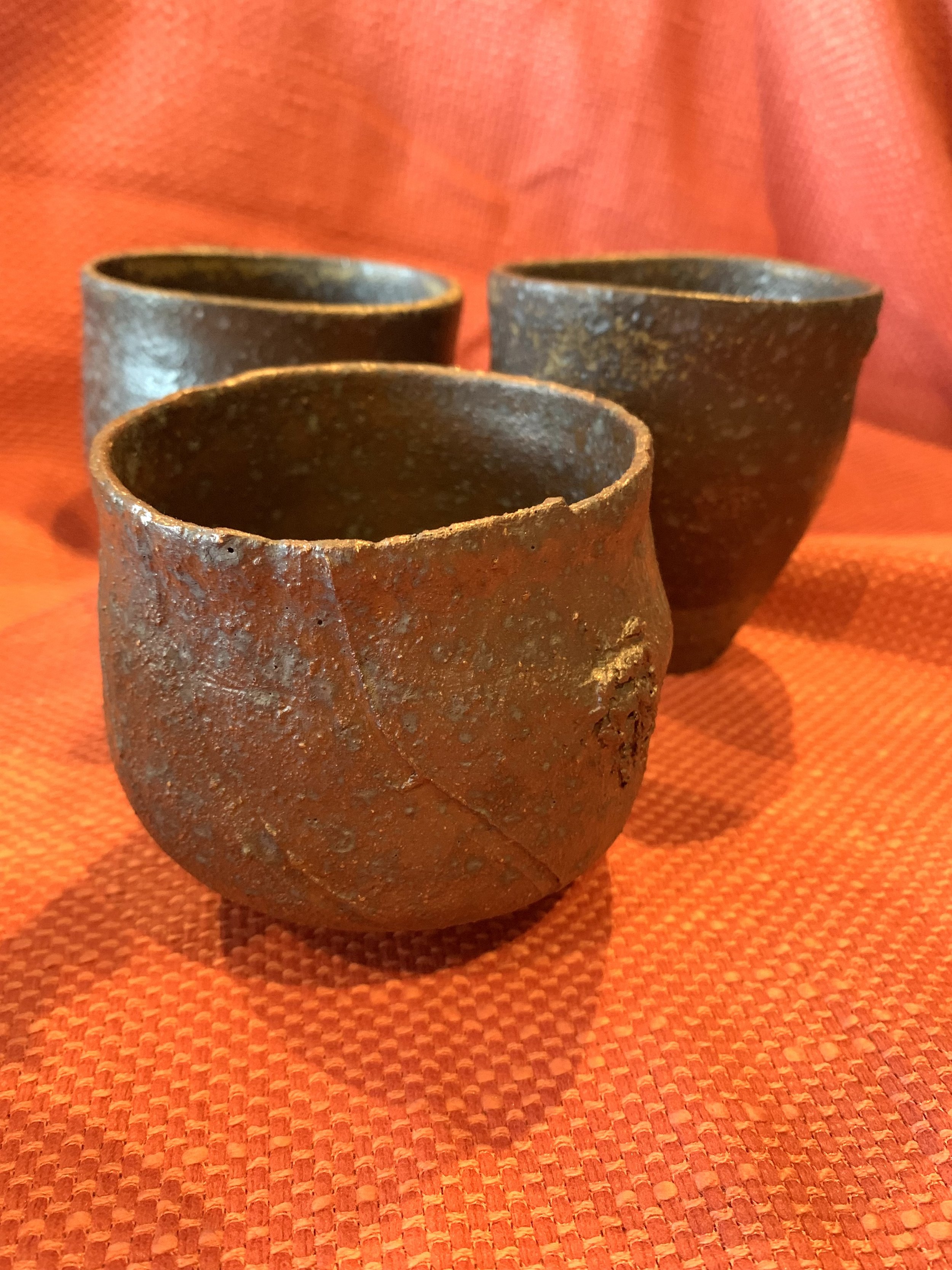 Textured cup, dark reduction fired stoneware