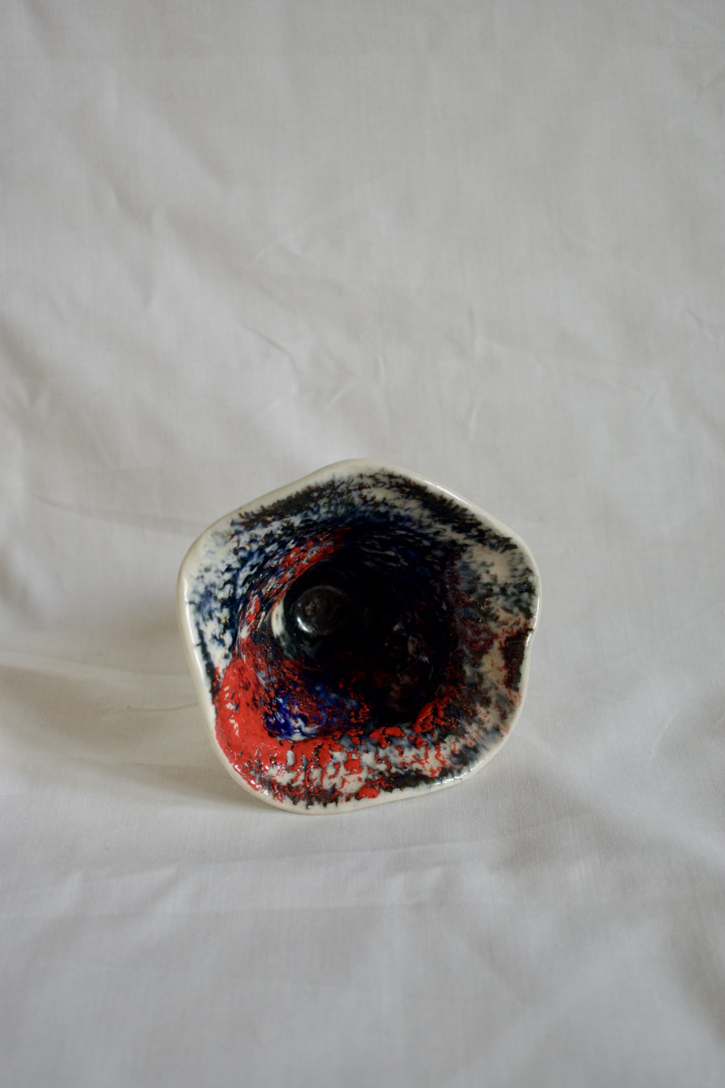 Small shell form, 2025. Thrown and altered stoneware with slips, oxides, and glaze