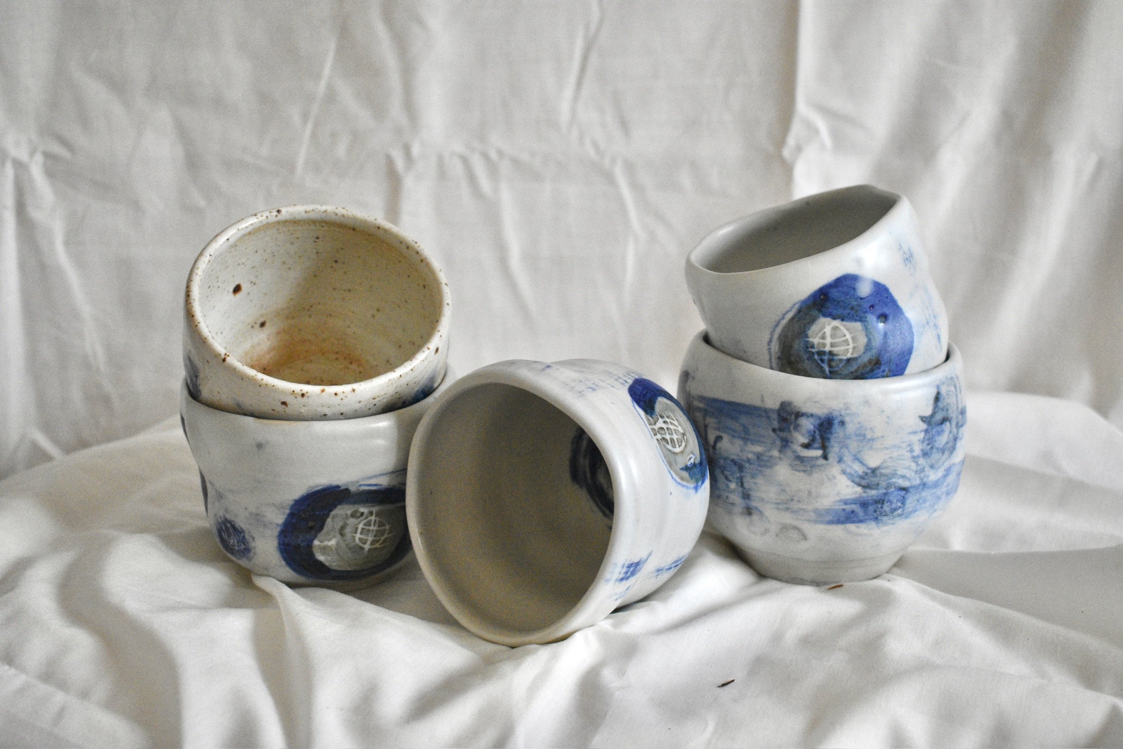 Cups, stoneware with slips, oxides, and glaze.