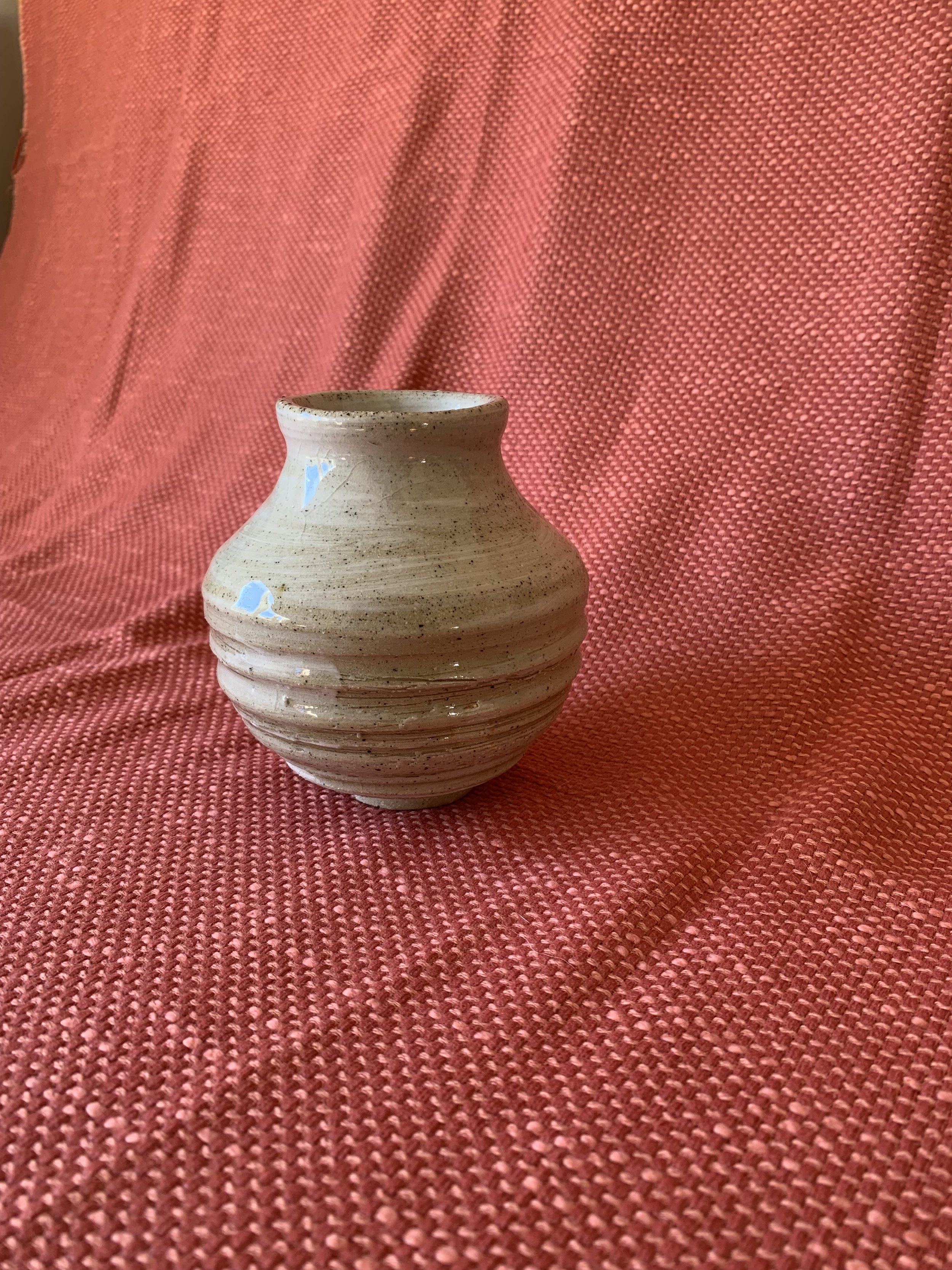 Small slip decorated footed stoneware vase