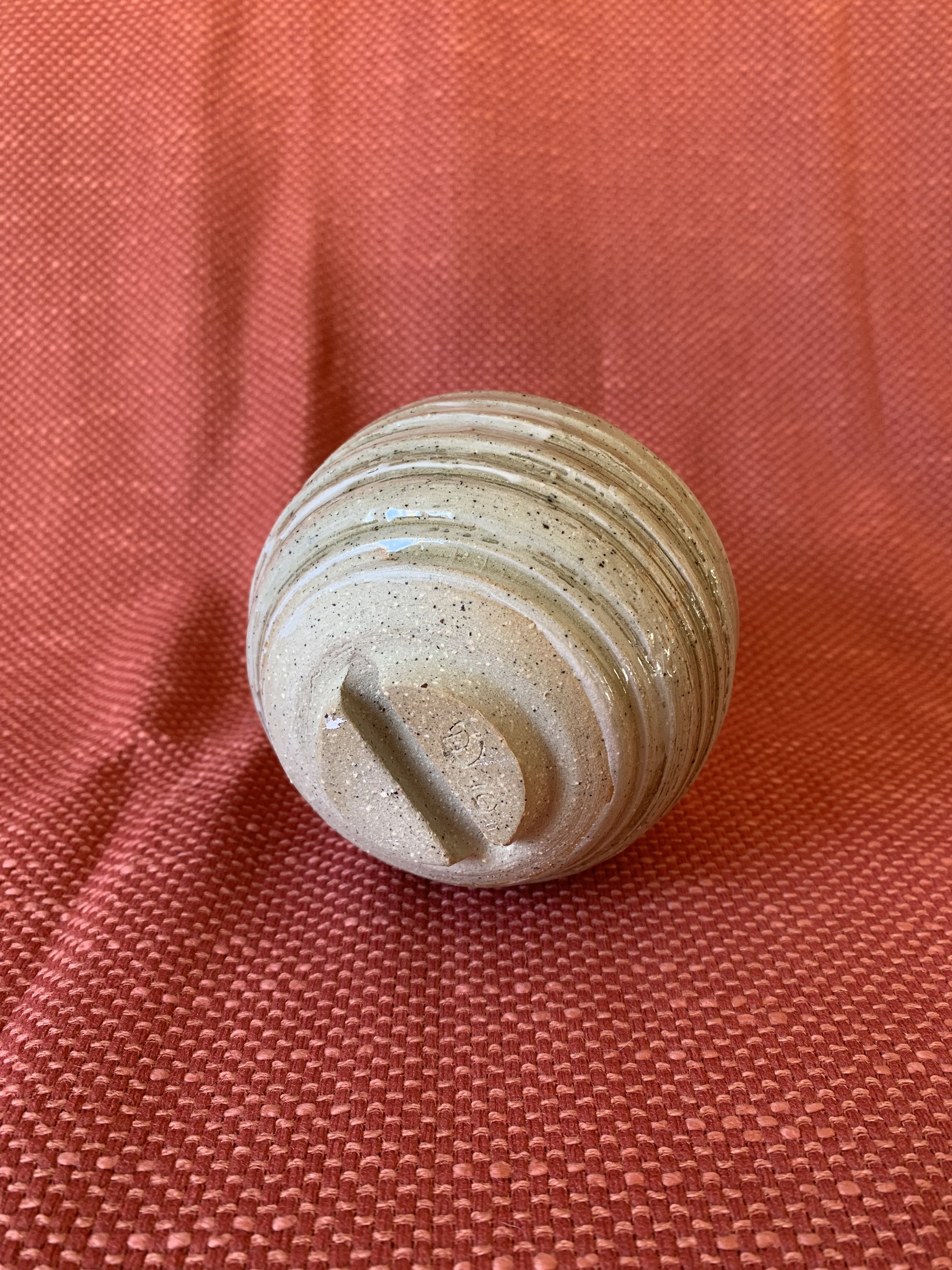 Foot detail, small slip decorated stoneware vase
