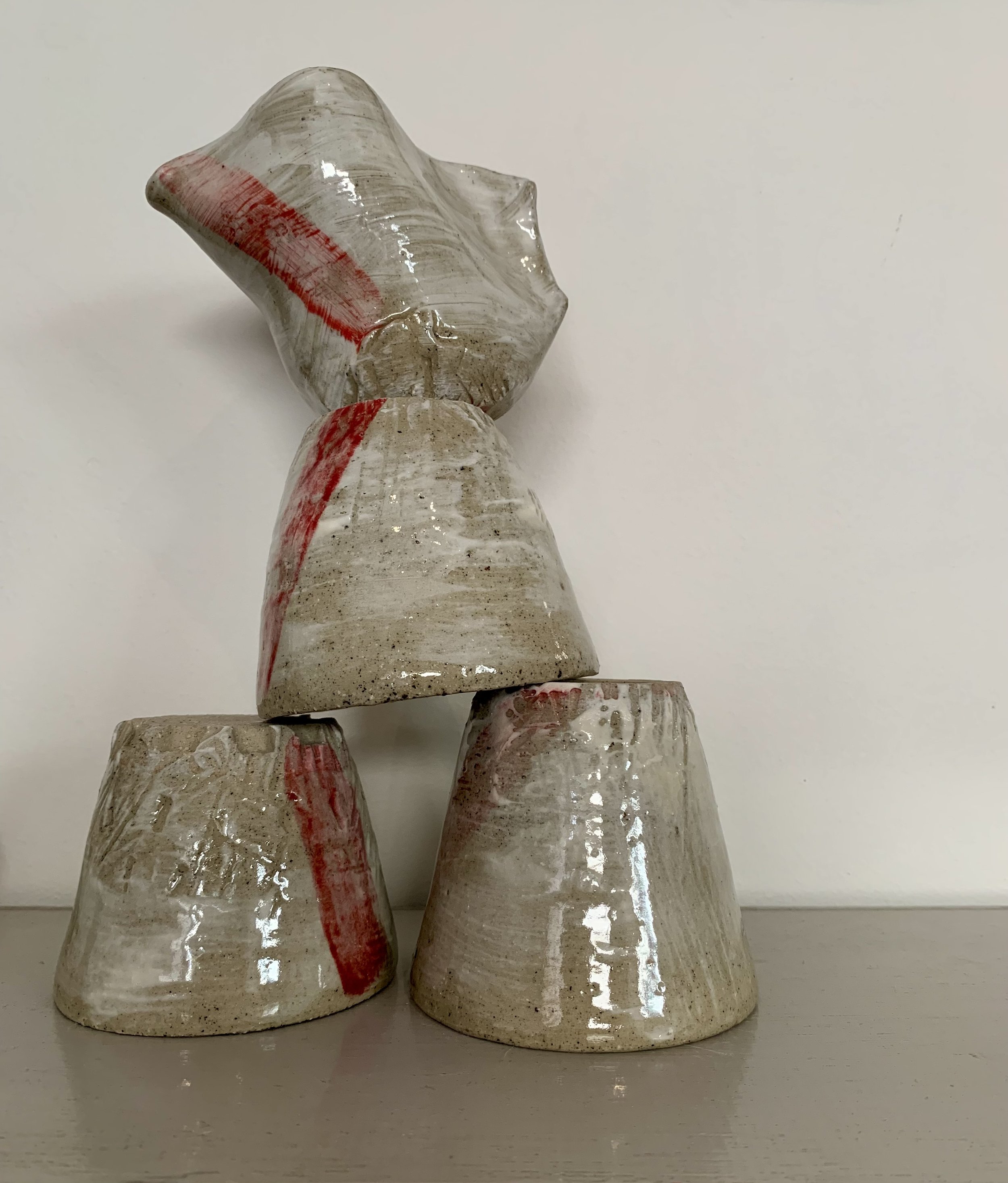 Three slip decorated and carved stoneware tumblers and pourer