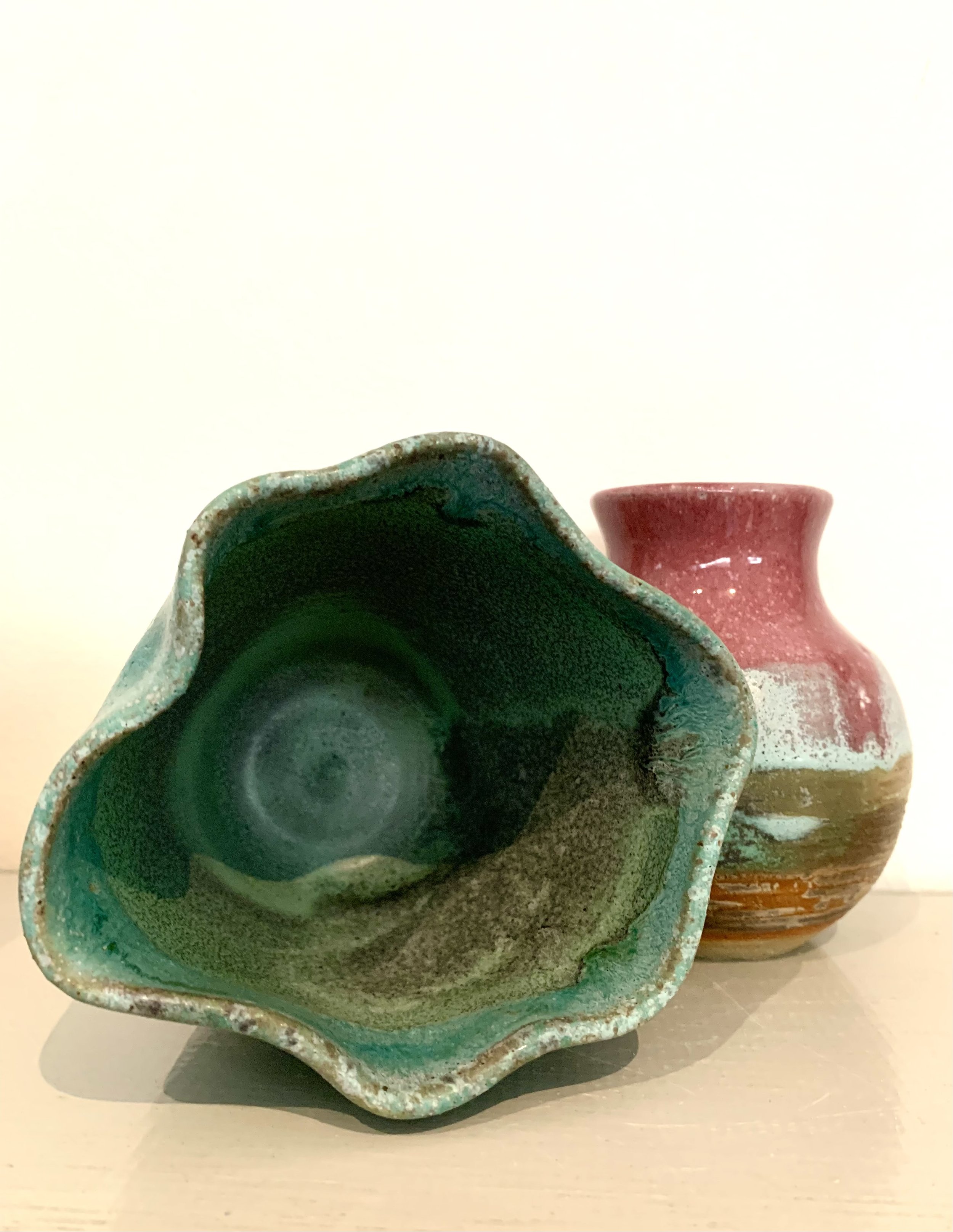 Pink thrown stoneware vase and bronzed green thrown and altered stoneware vase