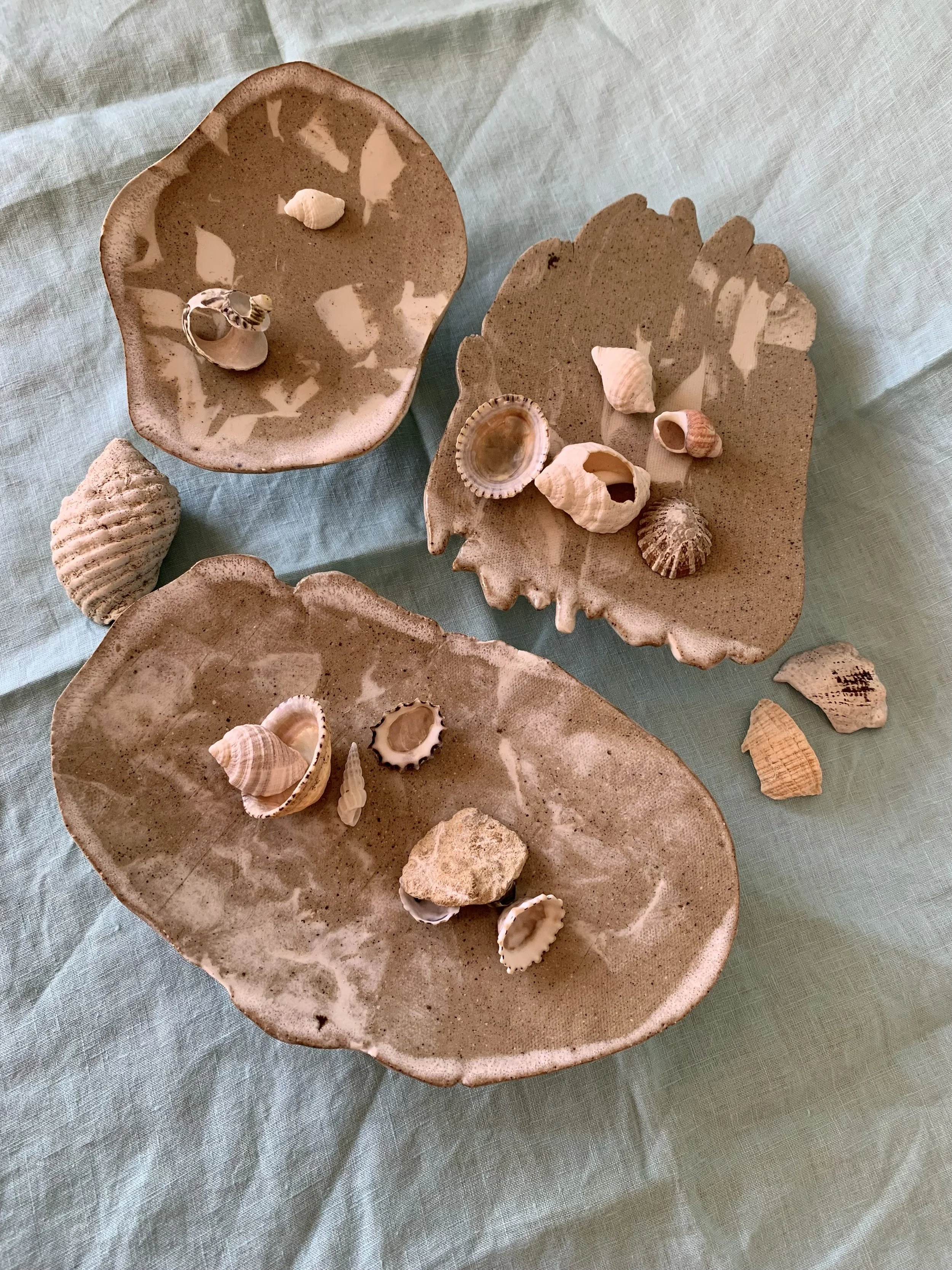 Three medium stilted Nerikomi serving dishes, clear glazed stoneware with slip