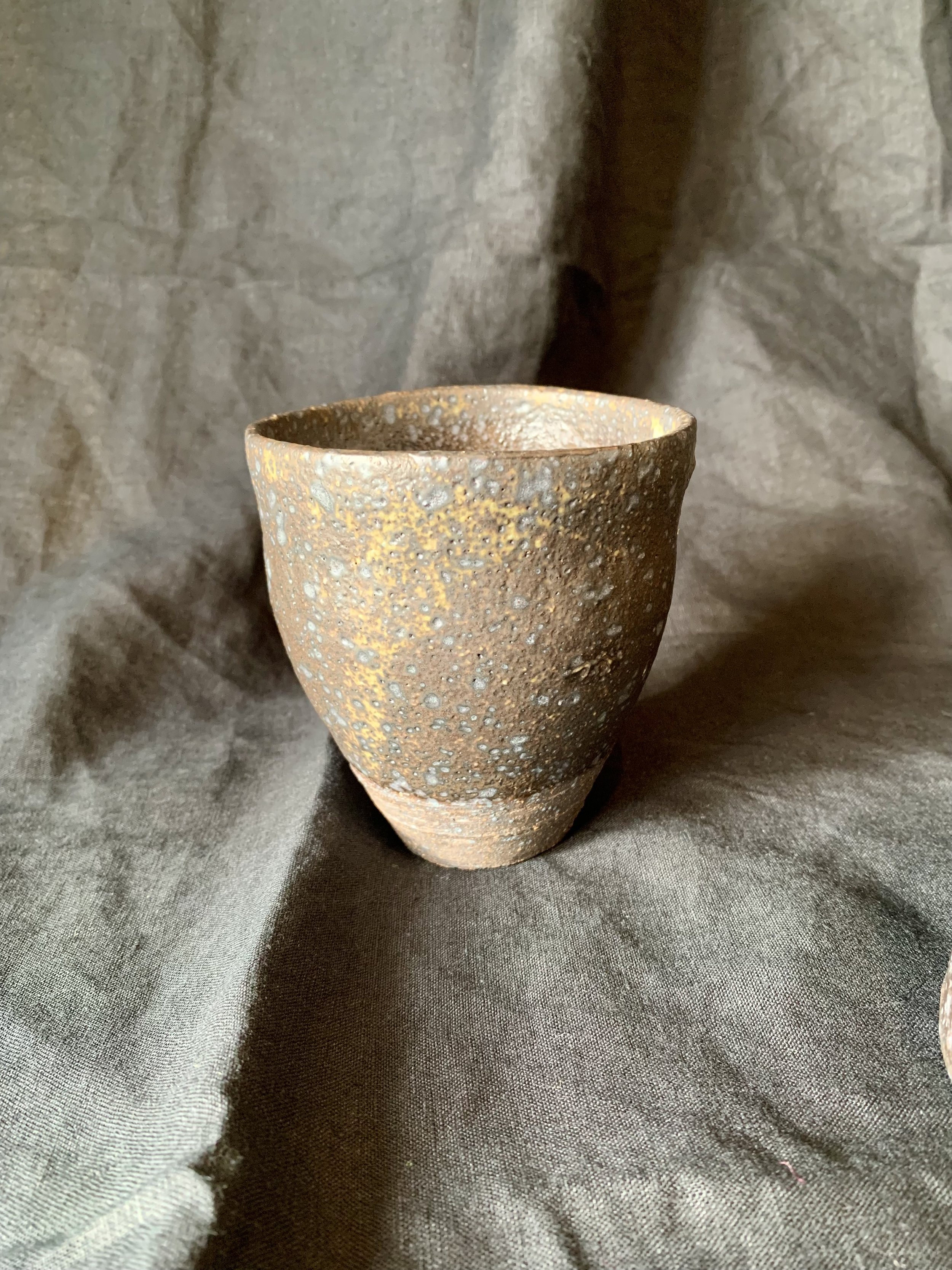 Tapered cup, dark reduction fired stoneware