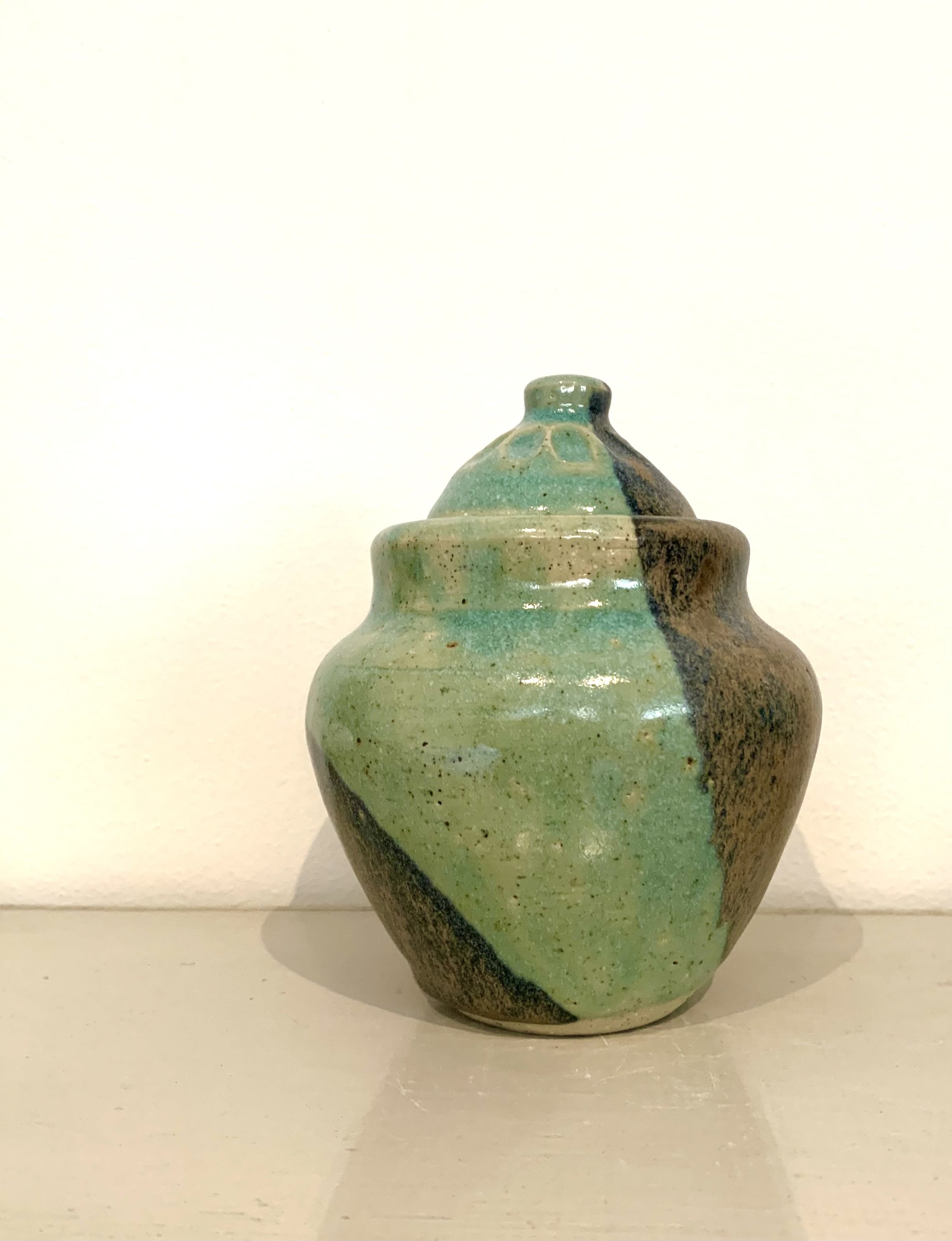 Thrown lidded jar, bronze and green glazed stoneware