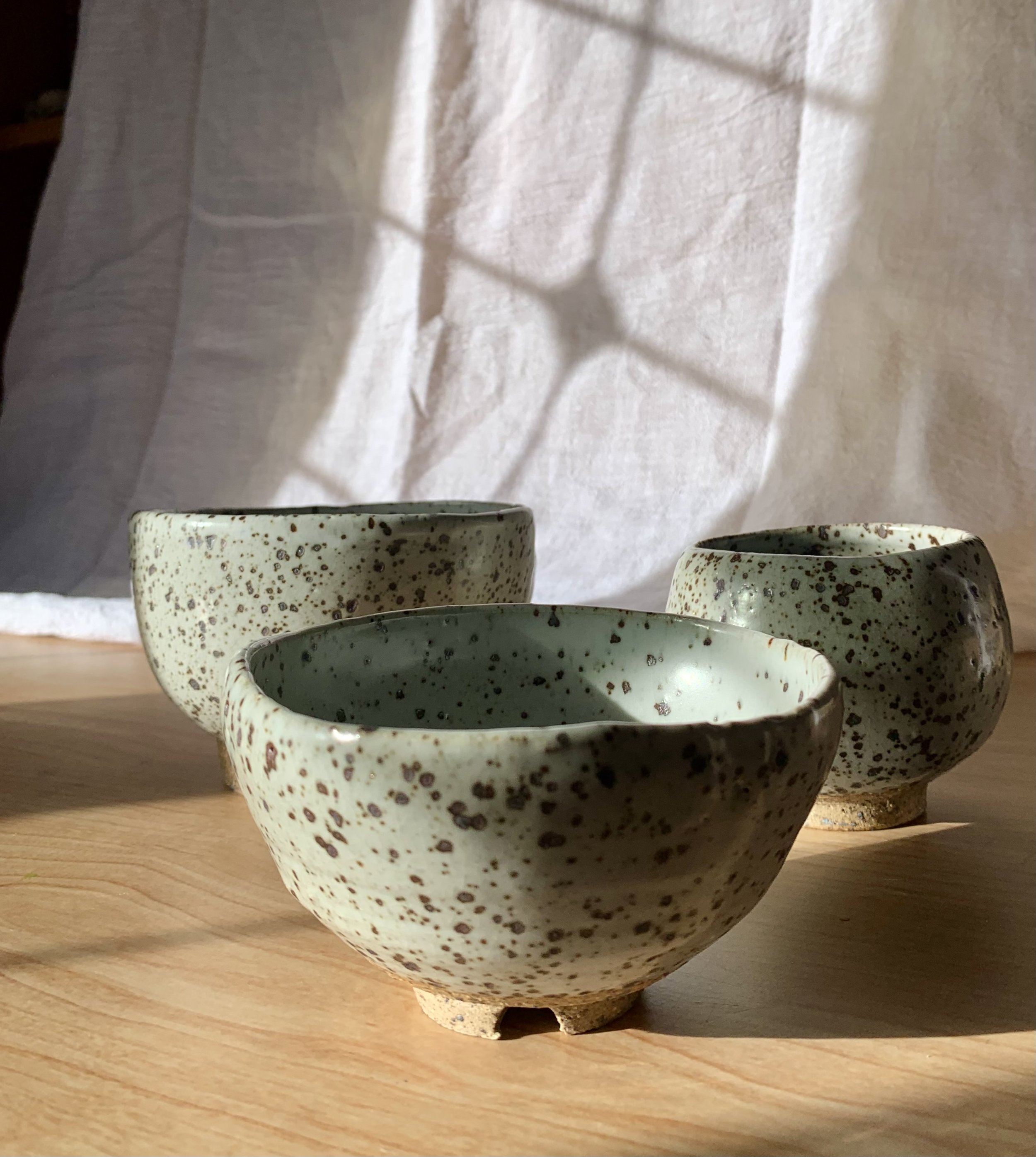 Set of three small footed bowls, reduction fired stoneware