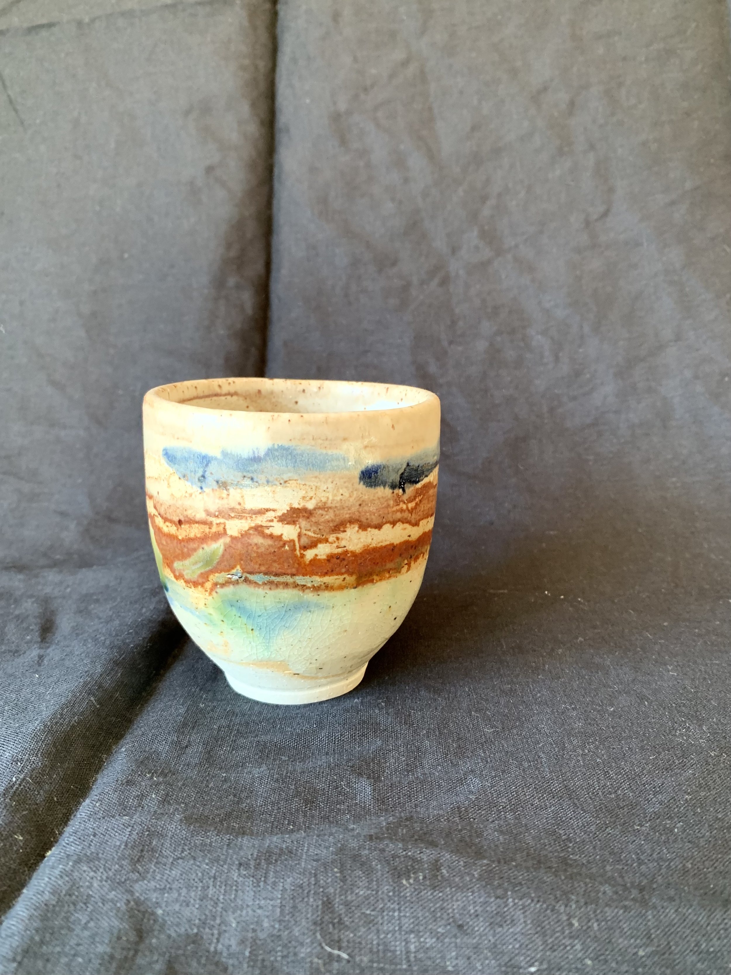 Stoneware cup decorated with oxides made from reclaimed metals and glazes incorporating reclaimed materials
